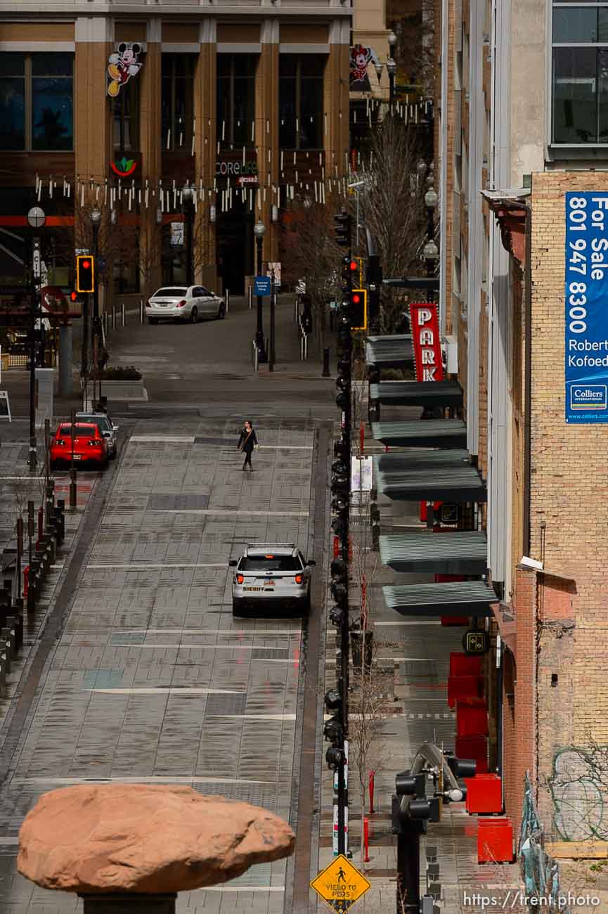 (Trent Nelson  |  The Salt Lake Tribune) A woman walks down Regent Street in downtown Salt Lake City on Monday, March 23, 2020.