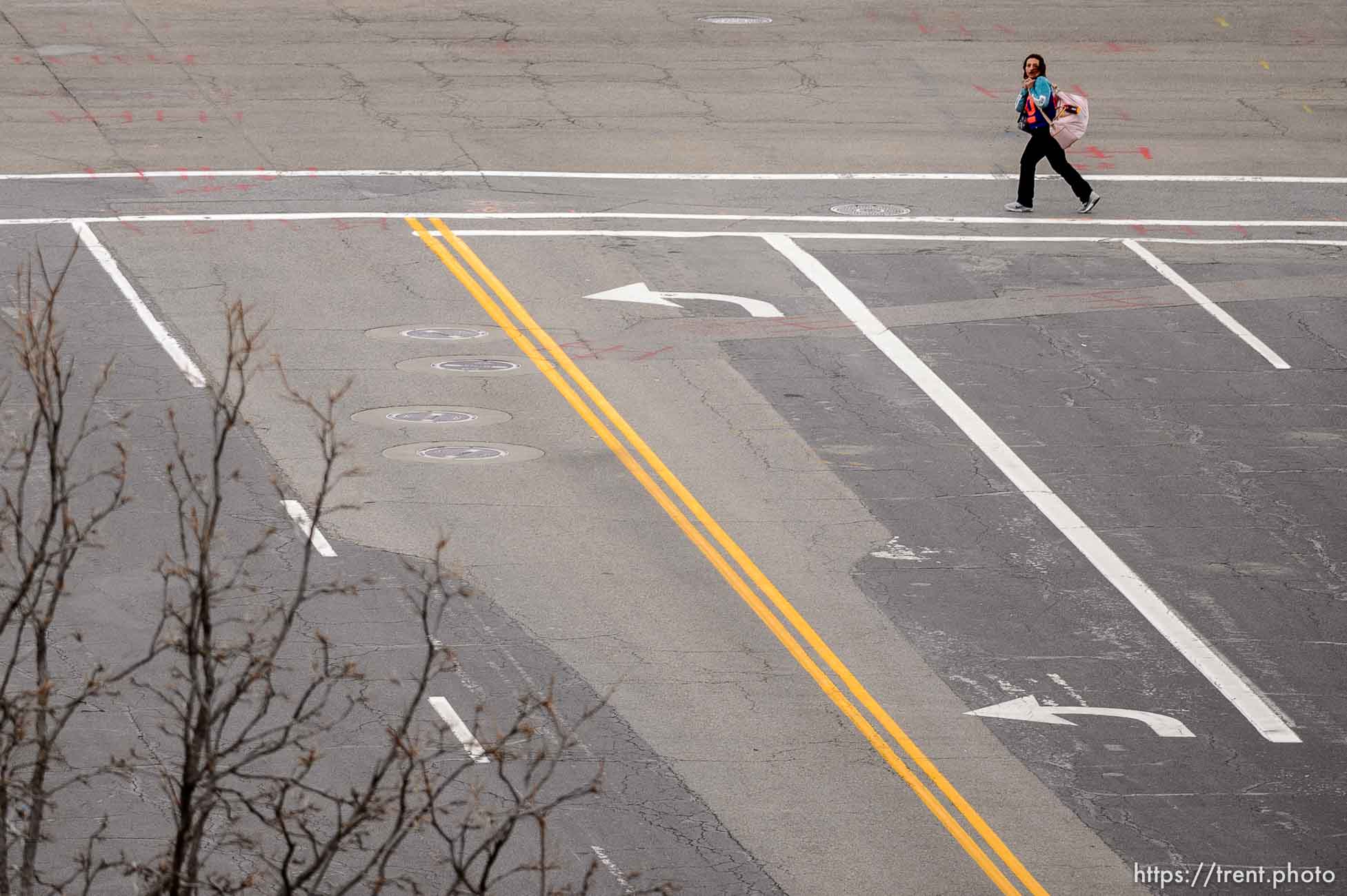 (Trent Nelson  |  The Salt Lake Tribune) A lone woman walks along 300 West as Salt Lake City continues to shelter in place to prevent the spread of COVID-19 on Monday, March 23, 2020.