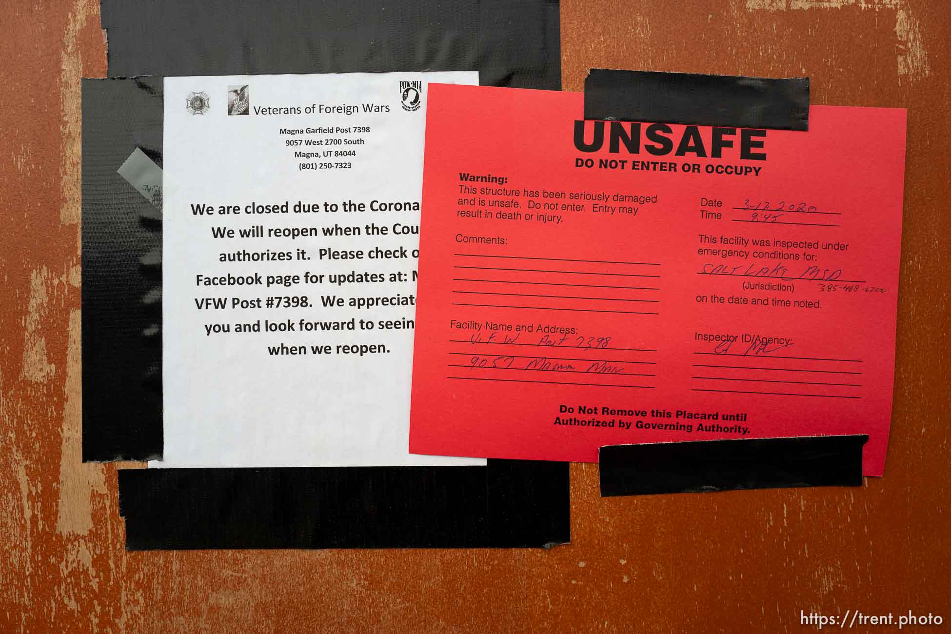 (Trent Nelson  |  The Salt Lake Tribune) A closure notice due to COVID-19 is covered up by a warning notice after earthquake damage to the VFW Post in Magna, as seen on Tuesday, March 24, 2020.