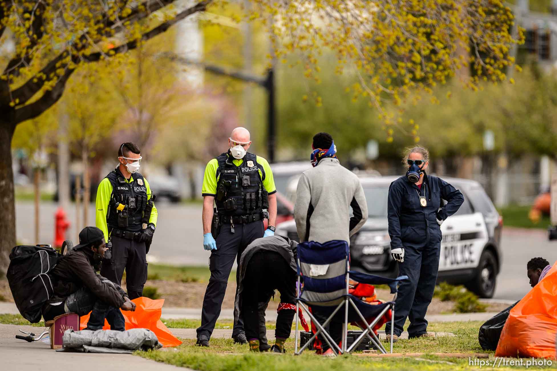 (Trent Nelson  |  The Salt Lake Tribune) Salt Lake City police and Salt Lake County Health Department personnel remove an encampment at 700 South State Street in Salt Lake City on Saturday, April 11, 2020.