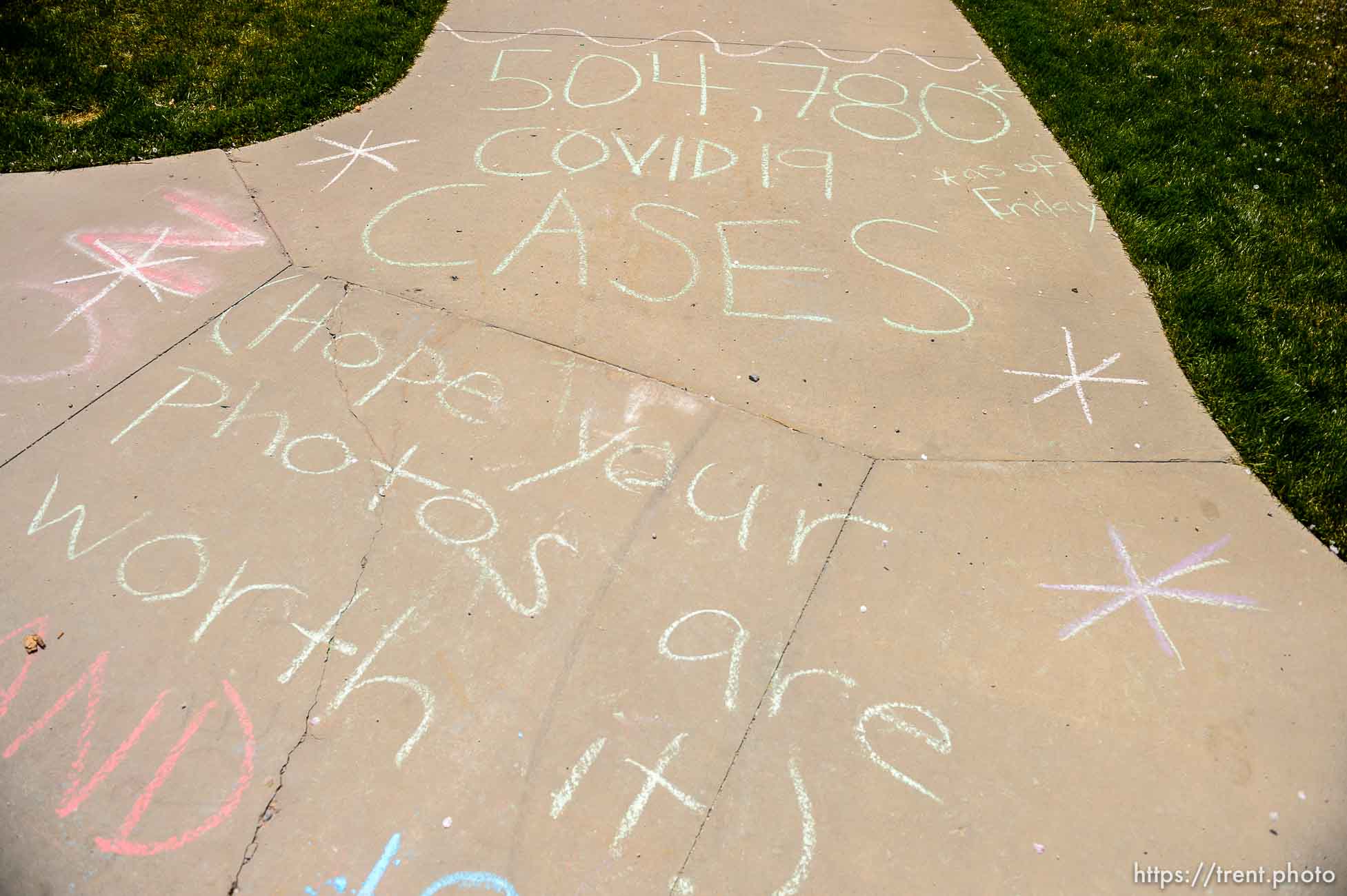 (Trent Nelson  |  The Salt Lake Tribune) Warnings written on the sidewalk trying to discourage the crowds of people walking in the cherry blossoms surrounding the state Capitol in Salt Lake City on Saturday, April 11, 2020.