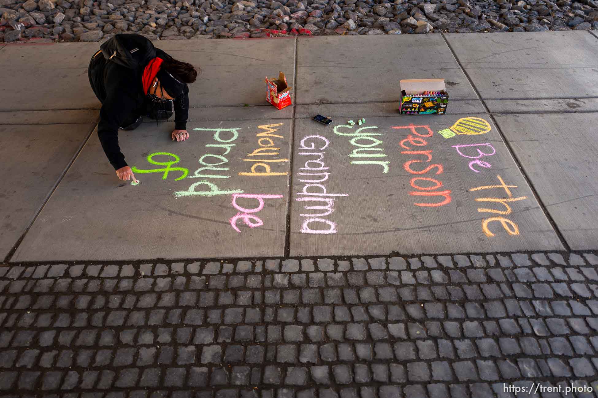 (Trent Nelson  |  The Salt Lake Tribune) Iola Idango writes hopeful messages on the sidewalk along North Temple in Salt Lake City on Saturday, May 23, 2020.