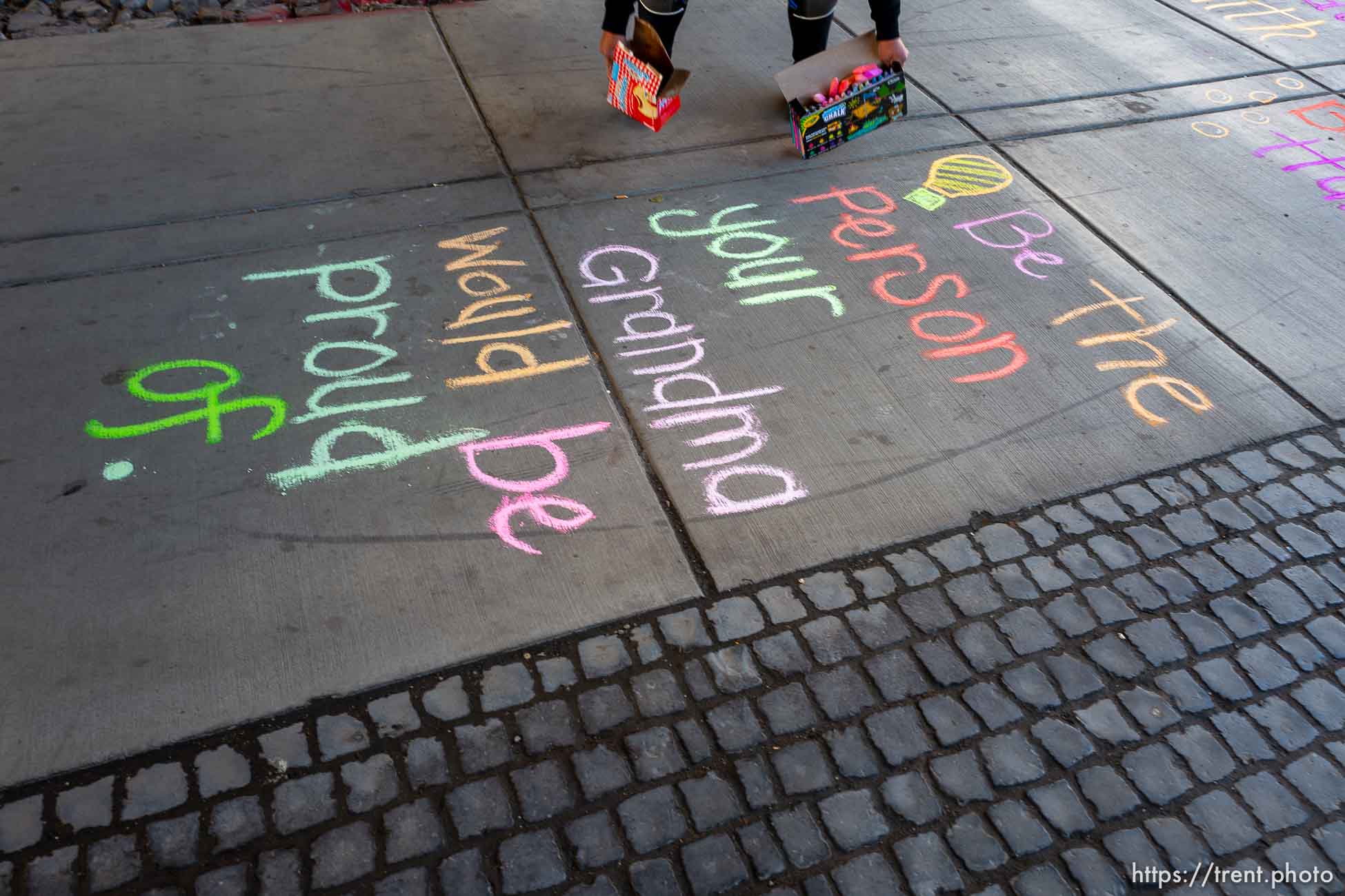 (Trent Nelson  |  The Salt Lake Tribune) Iola Idango writes hopeful messages on the sidewalk along North Temple in Salt Lake City on Saturday, May 23, 2020.