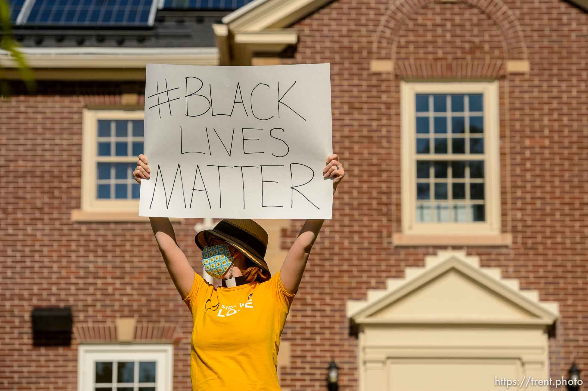 (Trent Nelson  |  The Salt Lake Tribune) Rev. Monica Dobbins holds a sign to passing traffic as a group of people protest police brutality in front of the First Unitarian Church in Salt Lake City on Friday, May 29, 2020.