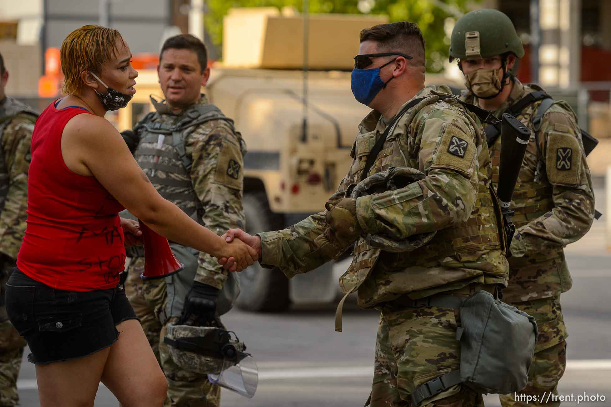 (Trent Nelson  |  The Salt Lake Tribune) Victoria Crosby shakes hands with and embraces members of the National Guard after she and a small group of Black Lives Matter activists knelt in front of the Public Safety Building in Salt Lake City on Tuesday, June 2, 2020.