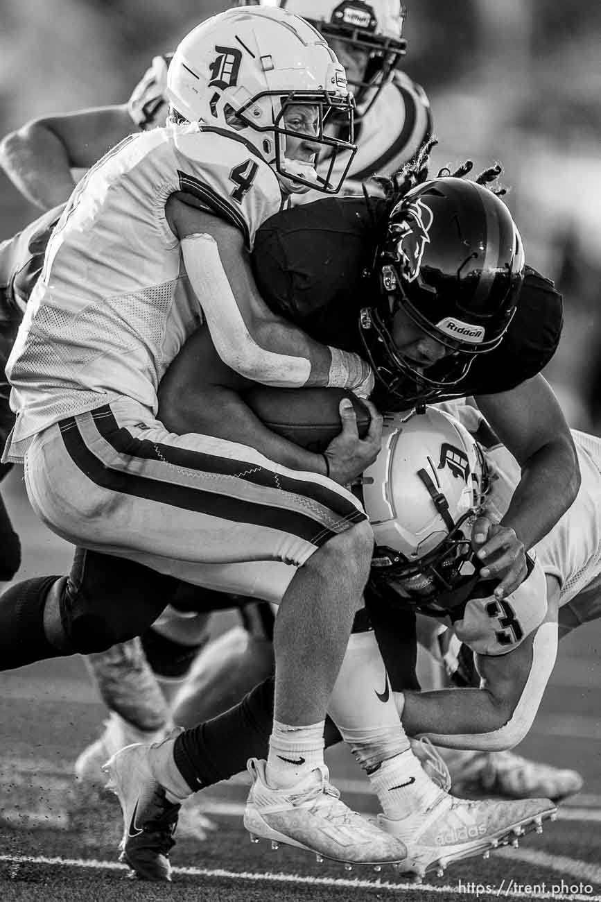 (Trent Nelson  |  The Salt Lake Tribune) Davis defenders bring down Herriman's Nu'u Tafisi as Herriman hosts Davis High School football, in Herriman on Thursday, Aug. 13, 2020.