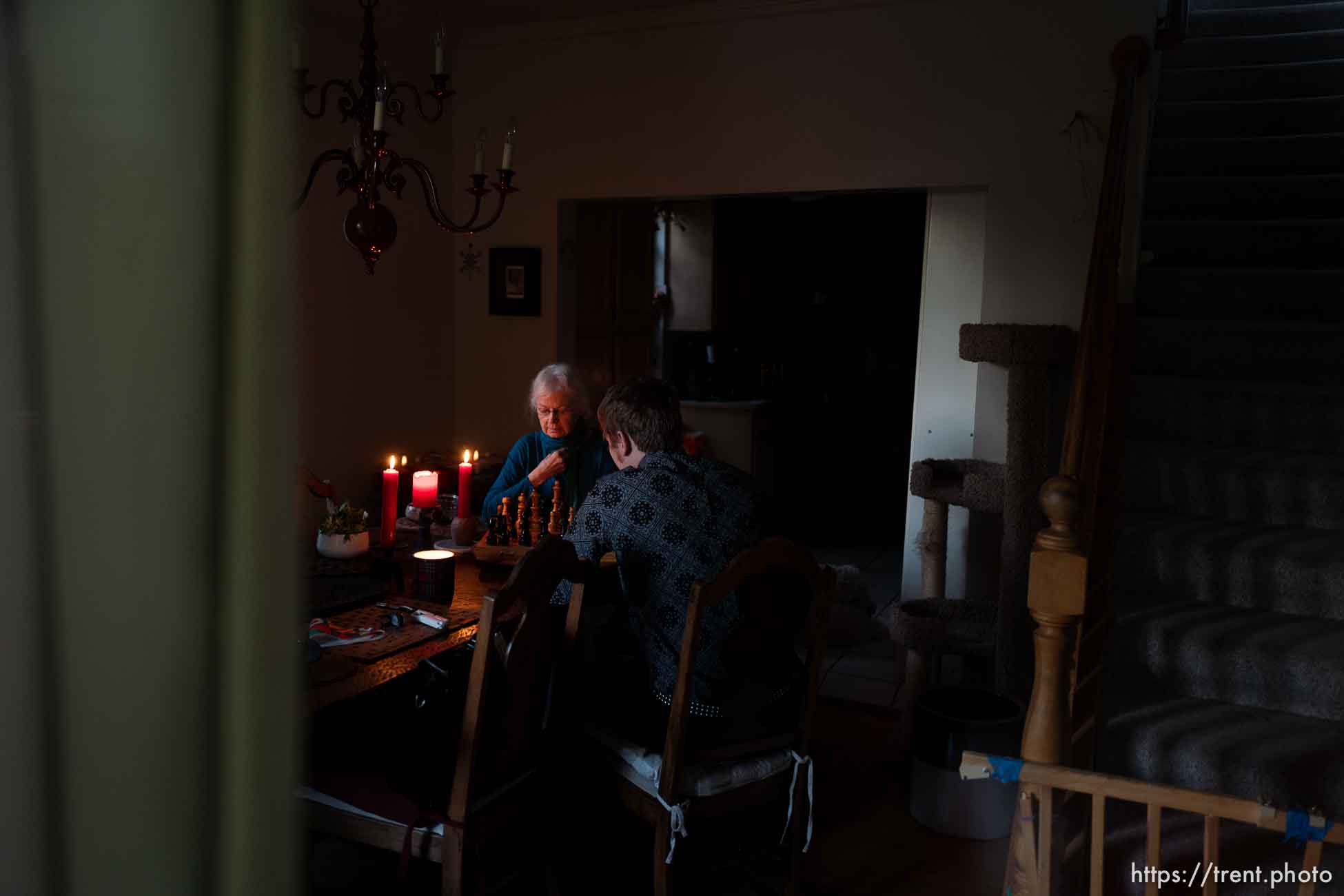 (Trent Nelson  |  The Salt Lake Tribune) Nick Kuzmack and his mother Frances Rowsell play chess by candlelight in their Salt Lake City home on Friday, Sept. 11, 2020. They have been without power since Tuesday's high winds.