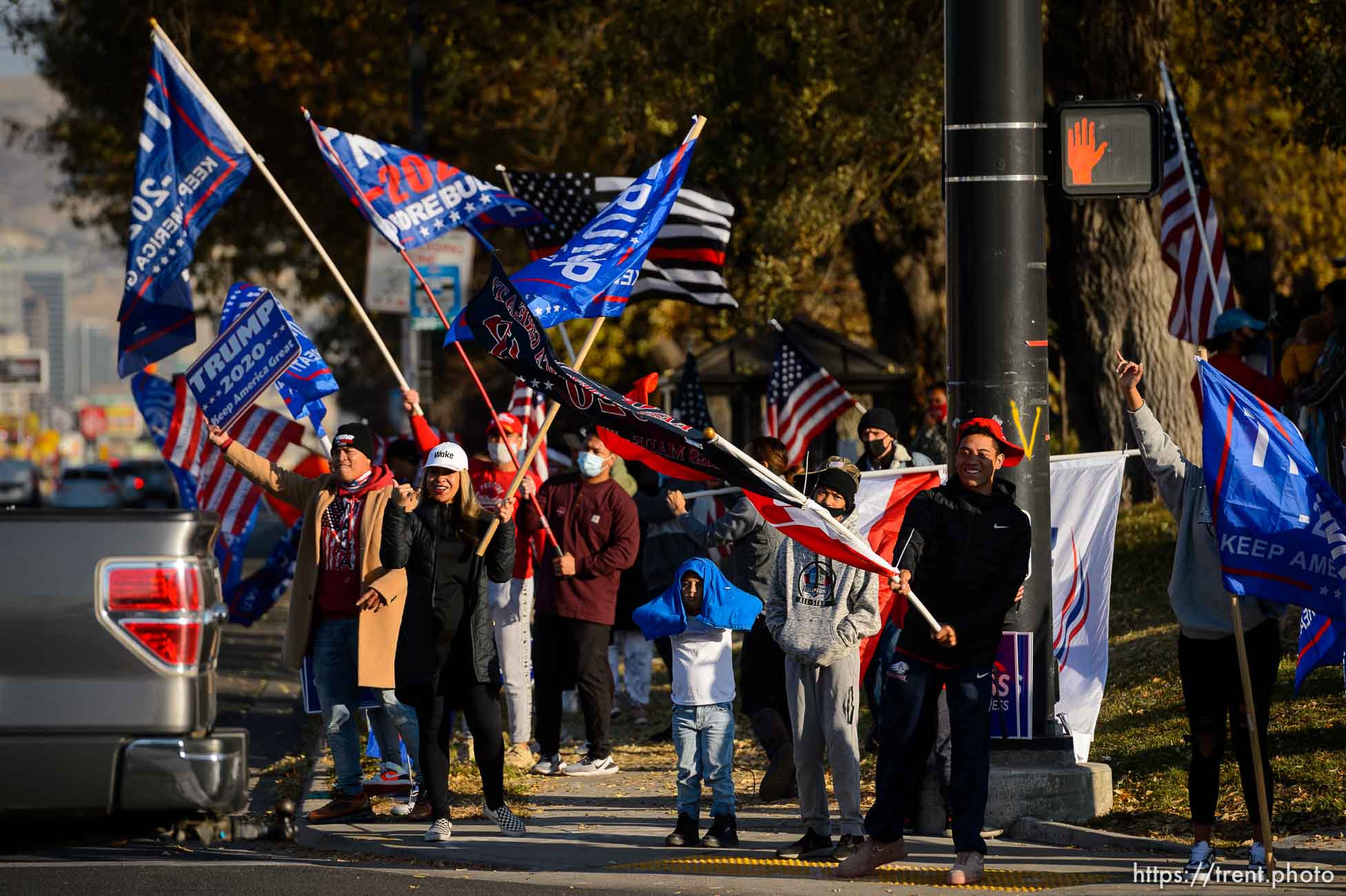 (Trent Nelson  |  The Salt Lake Tribune) A group of Trump supporters wave flags on the corner of 2100 S State Street in Salt Lake City on Tuesday, Nov. 3, 2020.