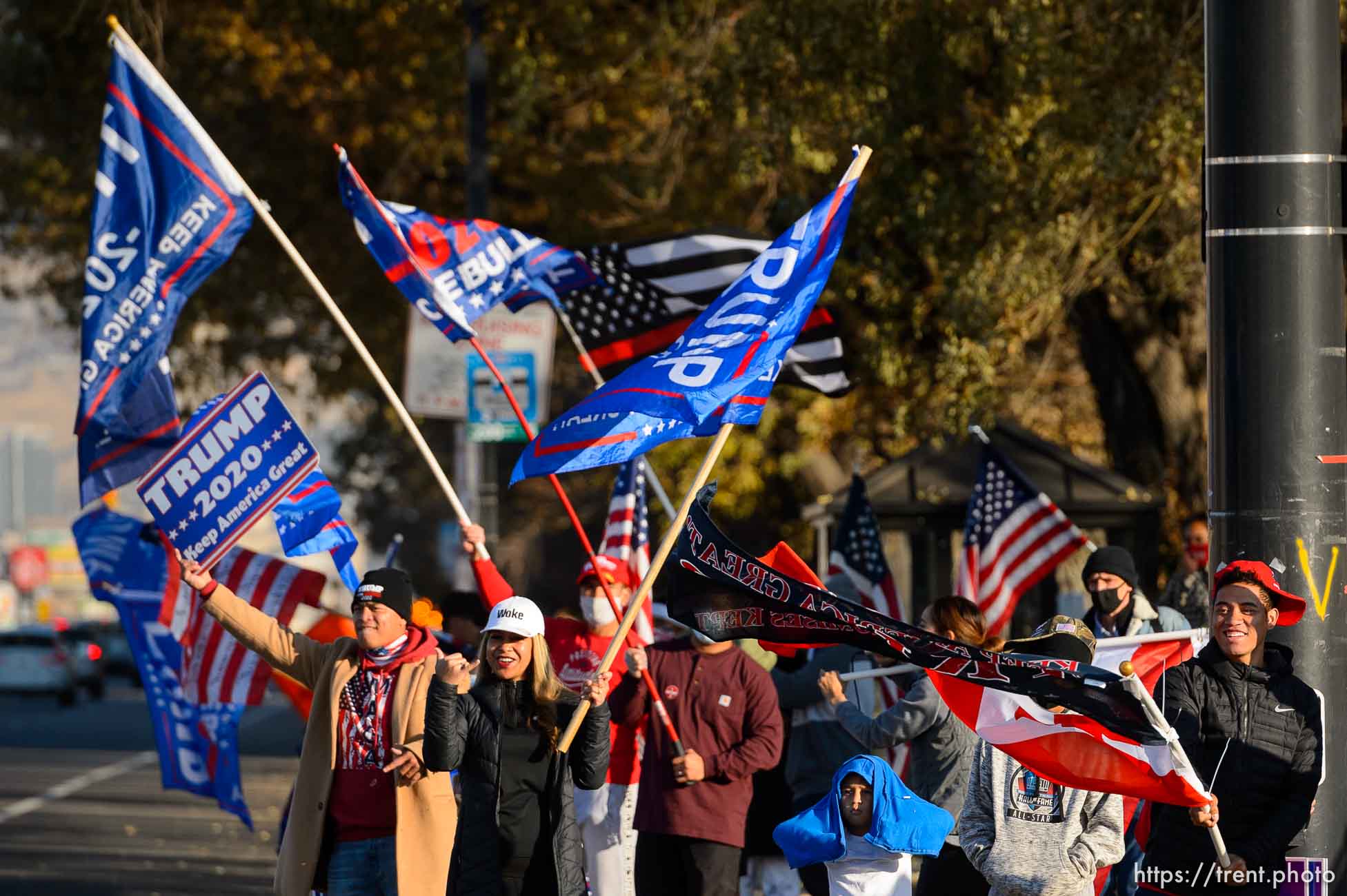 (Trent Nelson  |  The Salt Lake Tribune) A group of Trump supporters wave flags on the corner of 2100 S State Street in Salt Lake City on Tuesday, Nov. 3, 2020.