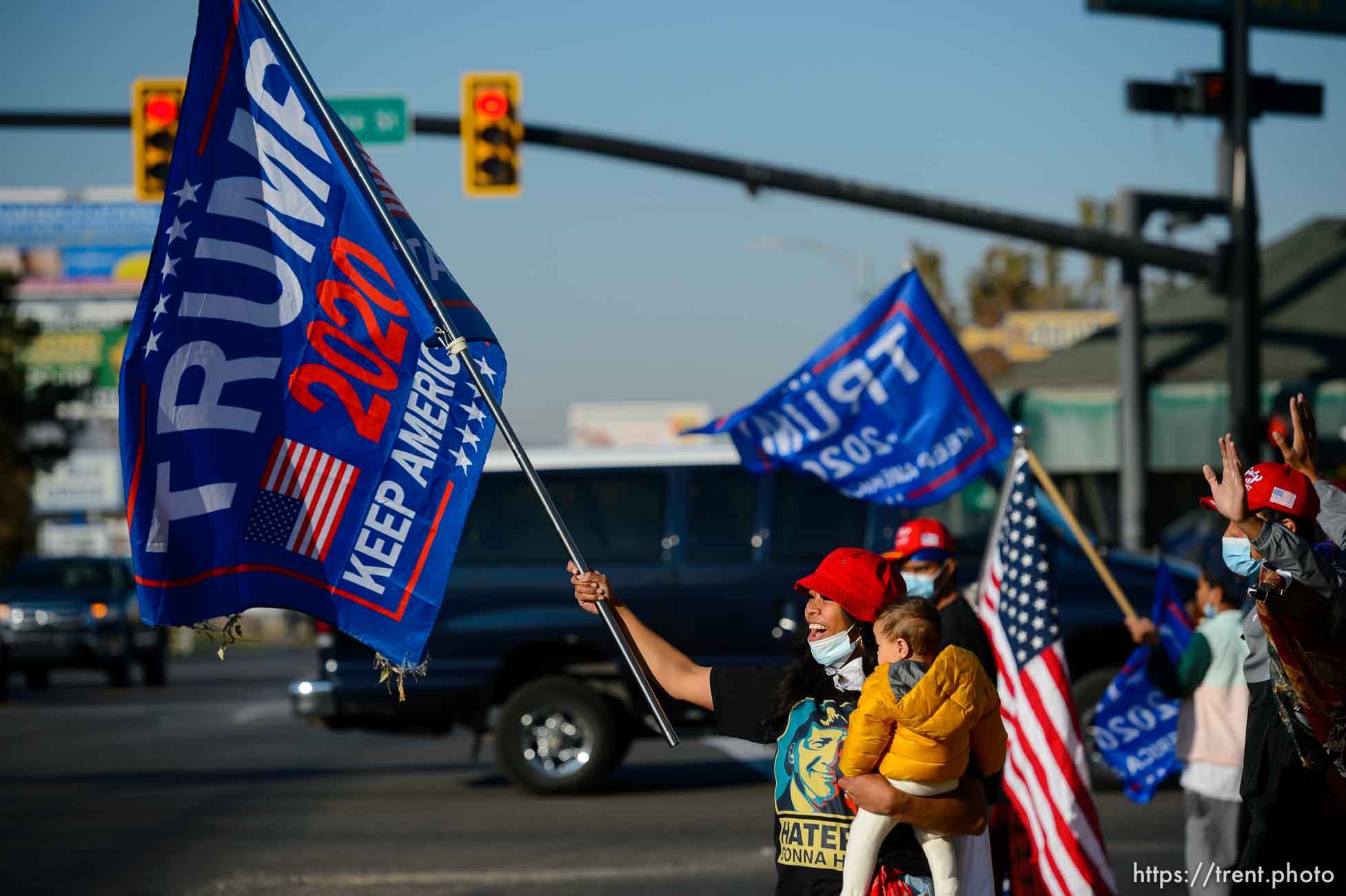 (Trent Nelson  |  The Salt Lake Tribune) A group of Trump supporters wave flags on the corner of 2100 S State Street in Salt Lake City on Tuesday, Nov. 3, 2020.