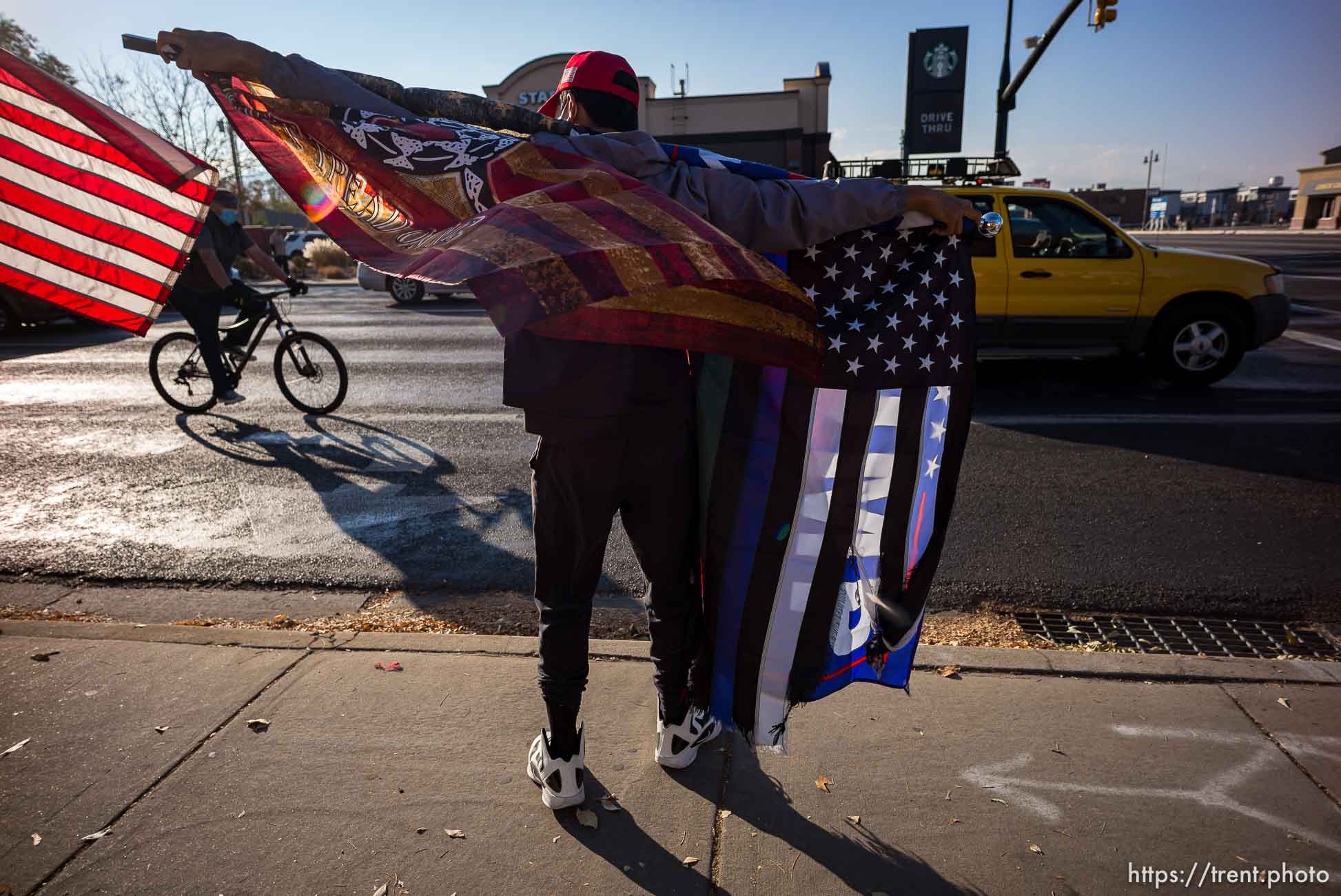 (Trent Nelson  |  The Salt Lake Tribune) A group of Trump supporters wave flags on the corner of 2100 S State Street in Salt Lake City on Tuesday, Nov. 3, 2020.