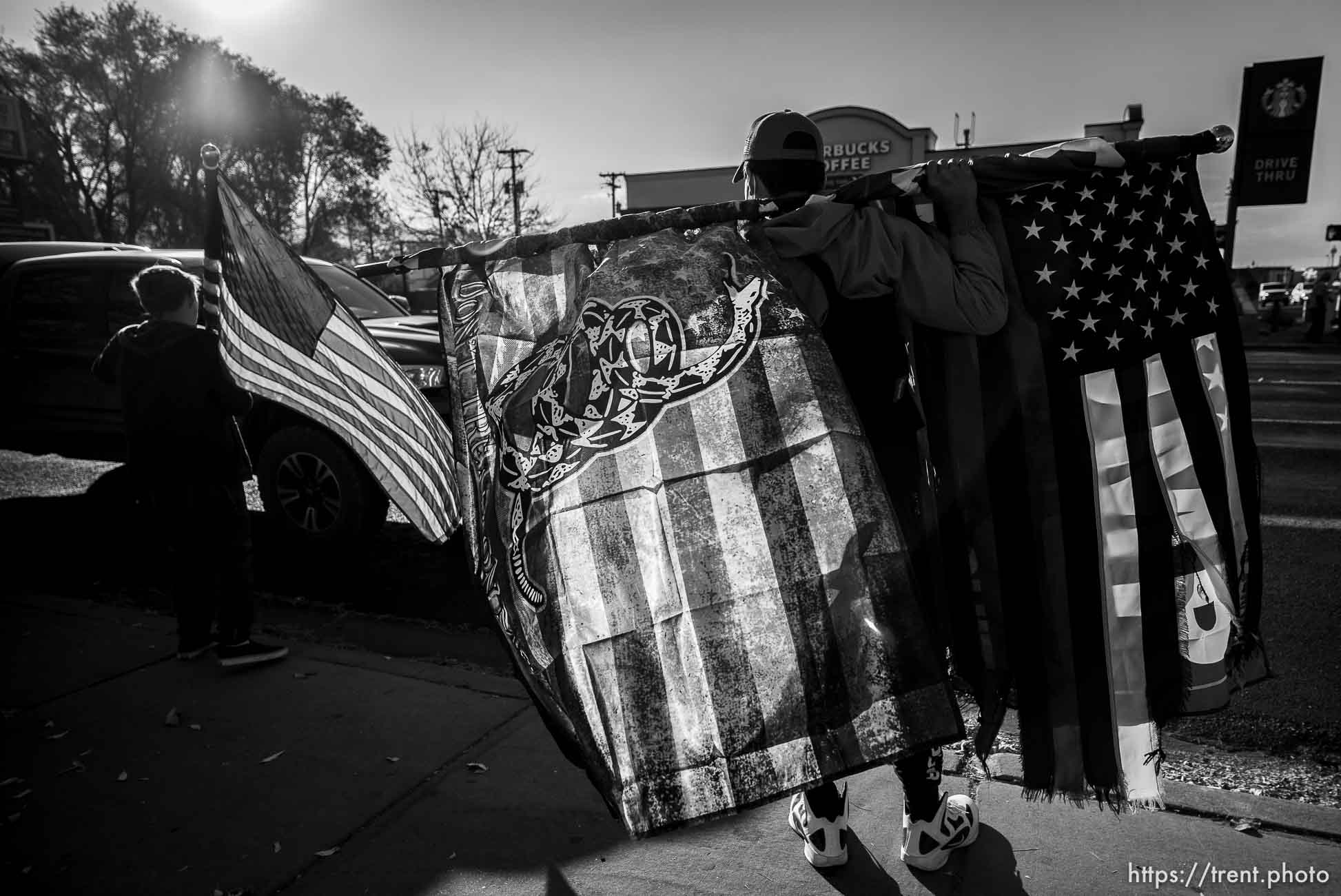 (Trent Nelson  |  The Salt Lake Tribune) A group of Trump supporters wave flags on the corner of 2100 S State Street in Salt Lake City on Tuesday, Nov. 3, 2020.