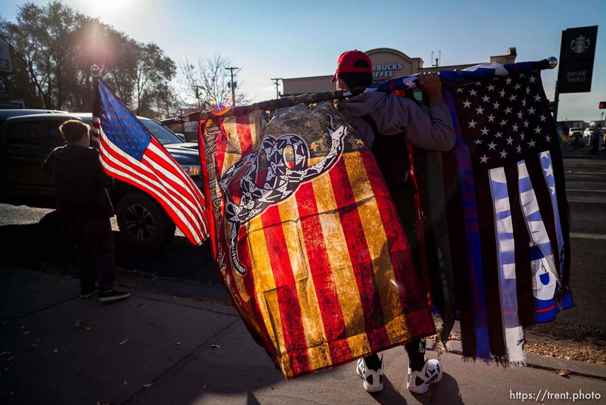 (Trent Nelson  |  The Salt Lake Tribune) A group of Trump supporters wave flags on the corner of 2100 S State Street in Salt Lake City on Tuesday, Nov. 3, 2020.