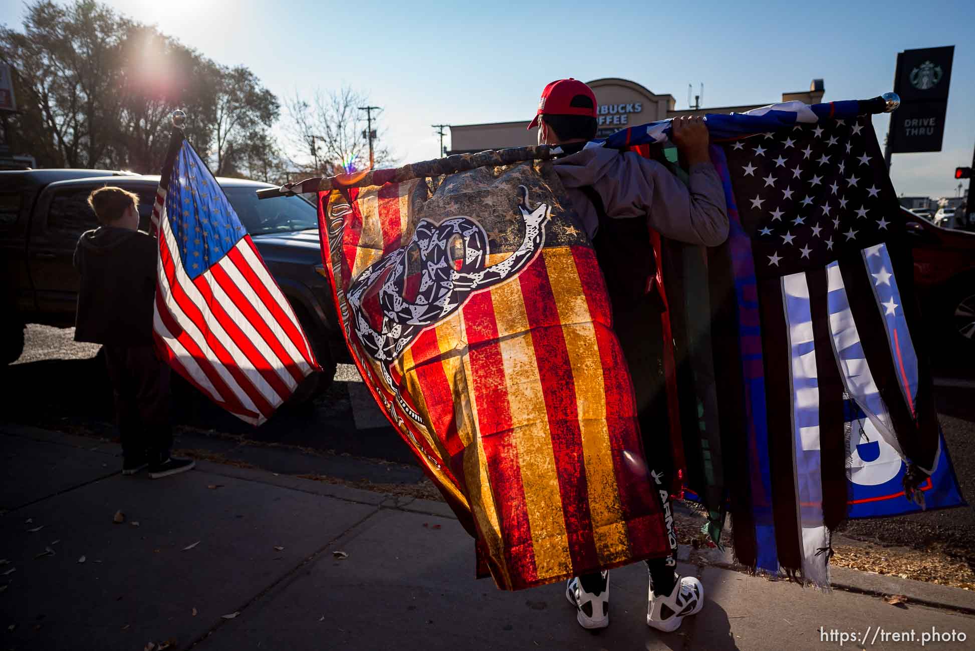 (Trent Nelson  |  The Salt Lake Tribune) A group of Trump supporters wave flags on the corner of 2100 S State Street in Salt Lake City on Tuesday, Nov. 3, 2020.