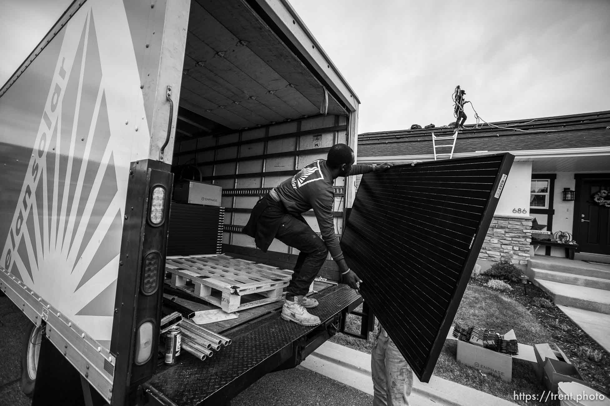 (Trent Nelson  |  The Salt Lake Tribune) A crew from Elan Solar installs solar panels on a Santaquin home on Friday, Nov. 6, 2020. roof: LJ Jenkins (green pants), RB Biel (jeans). ground: Eric Larkin (tan pants) and George Clement