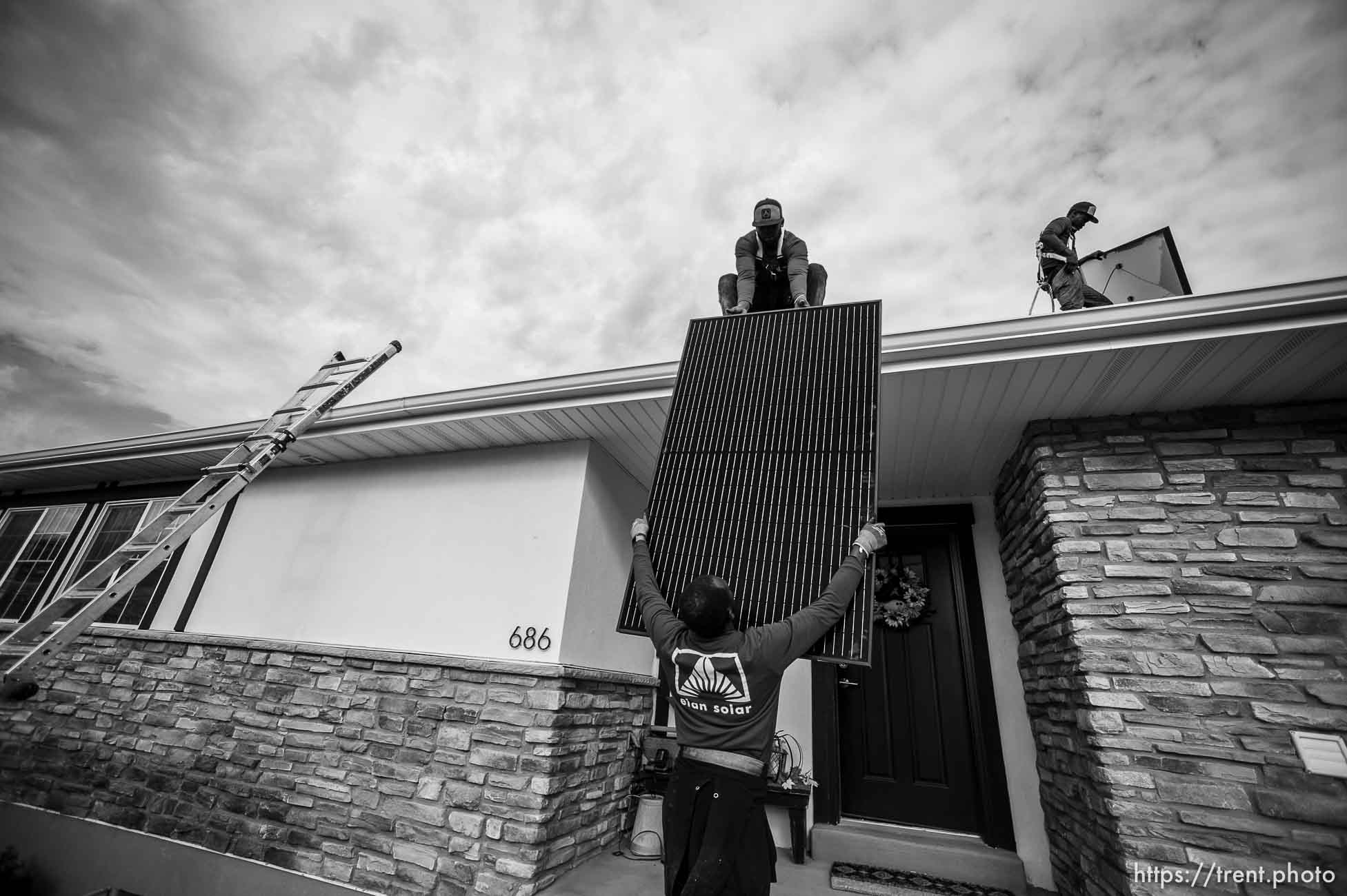 (Trent Nelson  |  The Salt Lake Tribune) A crew from Elan Solar installs solar panels on a Santaquin home on Friday, Nov. 6, 2020. roof: LJ Jenkins (green pants), RB Biel (jeans). ground: Eric Larkin (tan pants) and George Clement