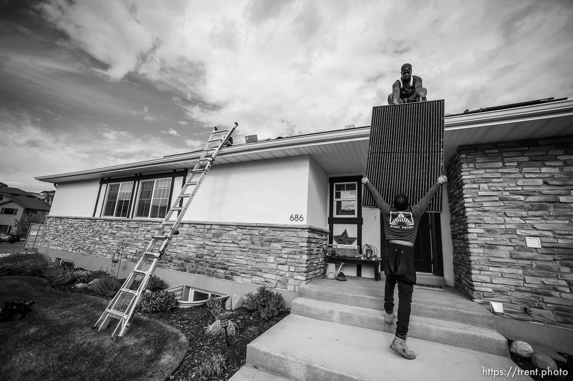 (Trent Nelson  |  The Salt Lake Tribune) A crew from Elan Solar installs solar panels on a Santaquin home on Friday, Nov. 6, 2020. roof: LJ Jenkins (green pants), RB Biel (jeans). ground: Eric Larkin (tan pants) and George Clement