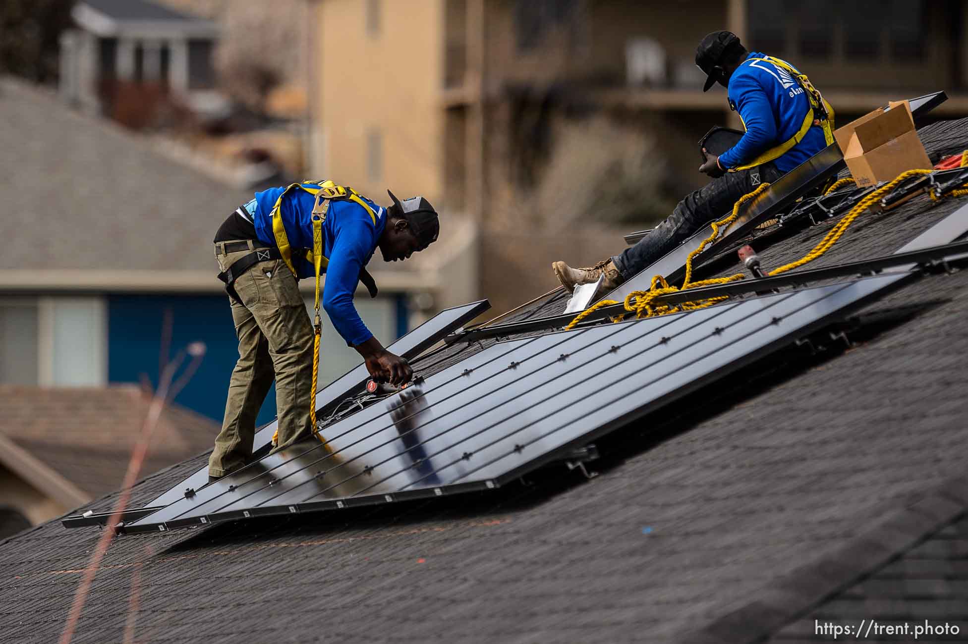 (Trent Nelson  |  The Salt Lake Tribune) LJ Jenkins and RB Biel, workers with Elan Solar, install solar panels on a Santaquin home on Friday, Nov. 6, 2020.