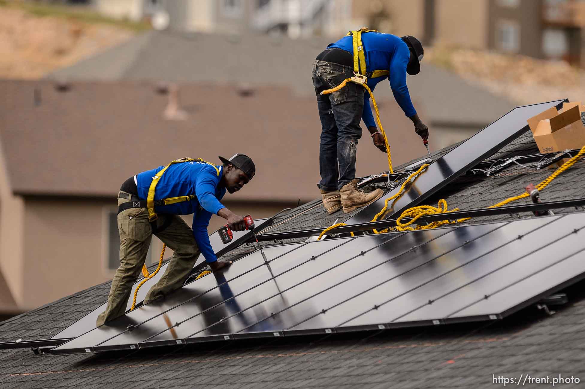 (Trent Nelson  |  The Salt Lake Tribune) LJ Jenkins and RB Biel, workers with Elan Solar, install solar panels on a Santaquin home on Friday, Nov. 6, 2020.