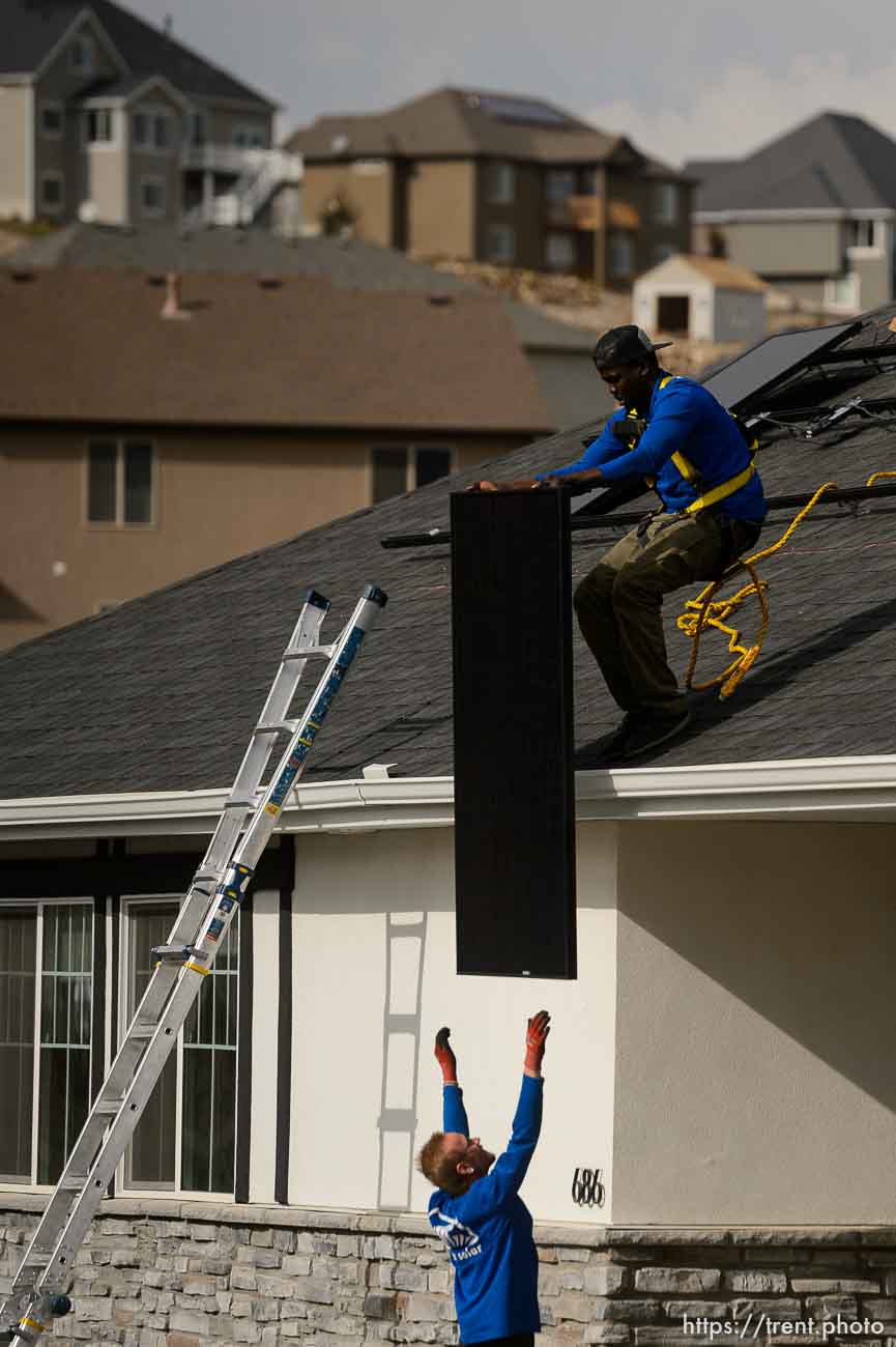 (Trent Nelson  |  The Salt Lake Tribune) A crew from Elan Solar installs solar panels on a Santaquin home on Friday, Nov. 6, 2020. roof: LJ Jenkins (green pants), RB Biel (jeans). ground: Eric Larkin (tan pants) and George Clement