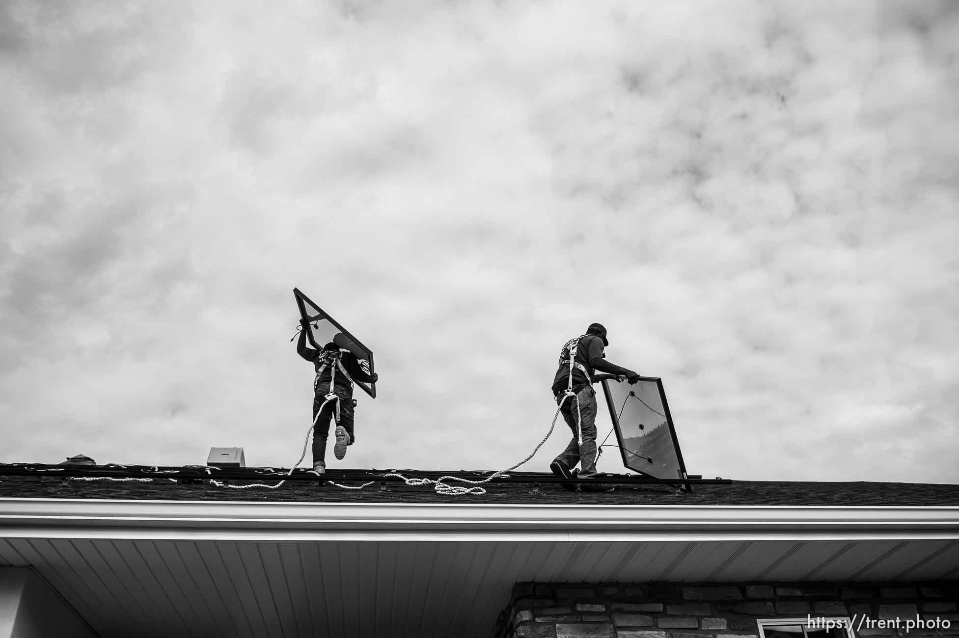 (Trent Nelson  |  The Salt Lake Tribune) A crew from Elan Solar installs solar panels on a Santaquin home on Friday, Nov. 6, 2020. roof: LJ Jenkins (green pants), RB Biel (jeans). ground: Eric Larkin (tan pants) and George Clement