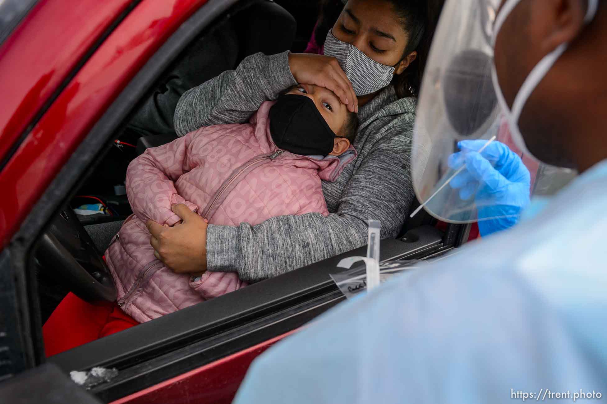 (Trent Nelson  |  The Salt Lake Tribune) Evandro Semedo tests Genisis Magana, in the arms of her mother Carla Miron, at the Utah National Guard’s mobile testing site for COVID-19 in Salt Lake City on Tuesday, Nov. 10, 2020.