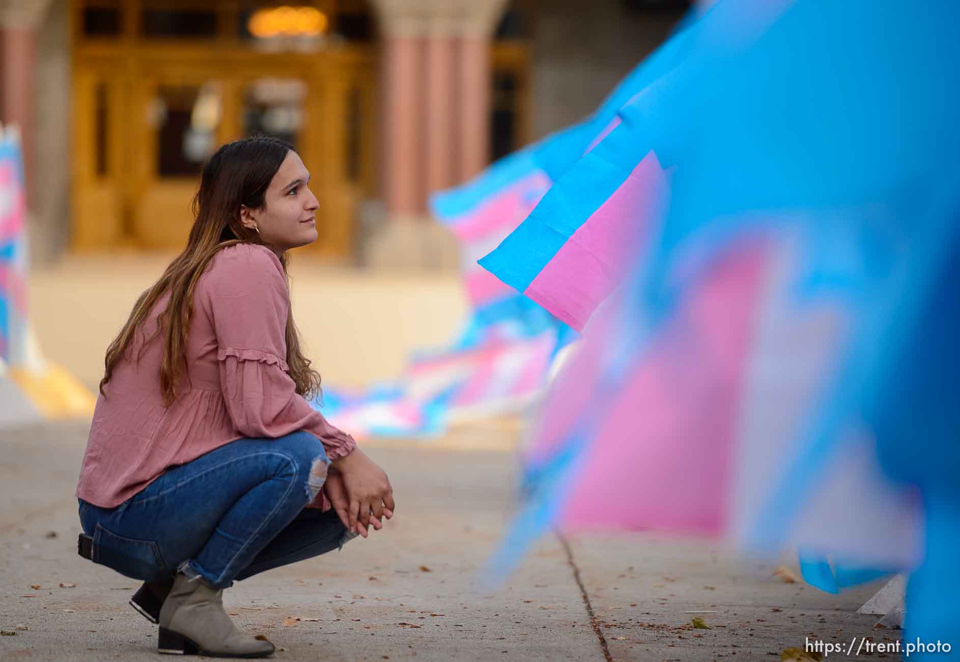 (Trent Nelson  |  The Salt Lake Tribune) Ermiya Fanaeian poses for a photographer Robin Pendegrast with Trans Pride flags marking Transgender Awareness Week at City Hall in Salt Lake City on Tuesday, Nov. 17, 2020. Each of the more than 300 Trans Pride flags stands in remembrance of a transgender person murdered in the last year.