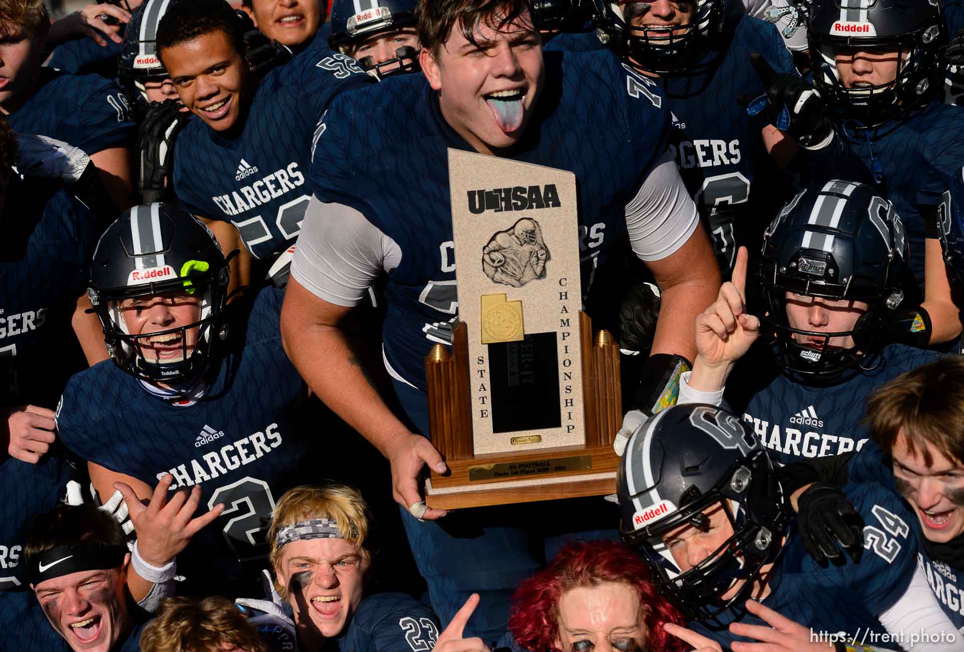 (Trent Nelson  |  The Salt Lake Tribune) Corner Canyon's Jackson Light holds the trophy while celebrating with teammates after the 6A state football championship game against Lone Peak at Cedar Valley High School in Eagle Mountain on Friday, Nov. 20, 2020.