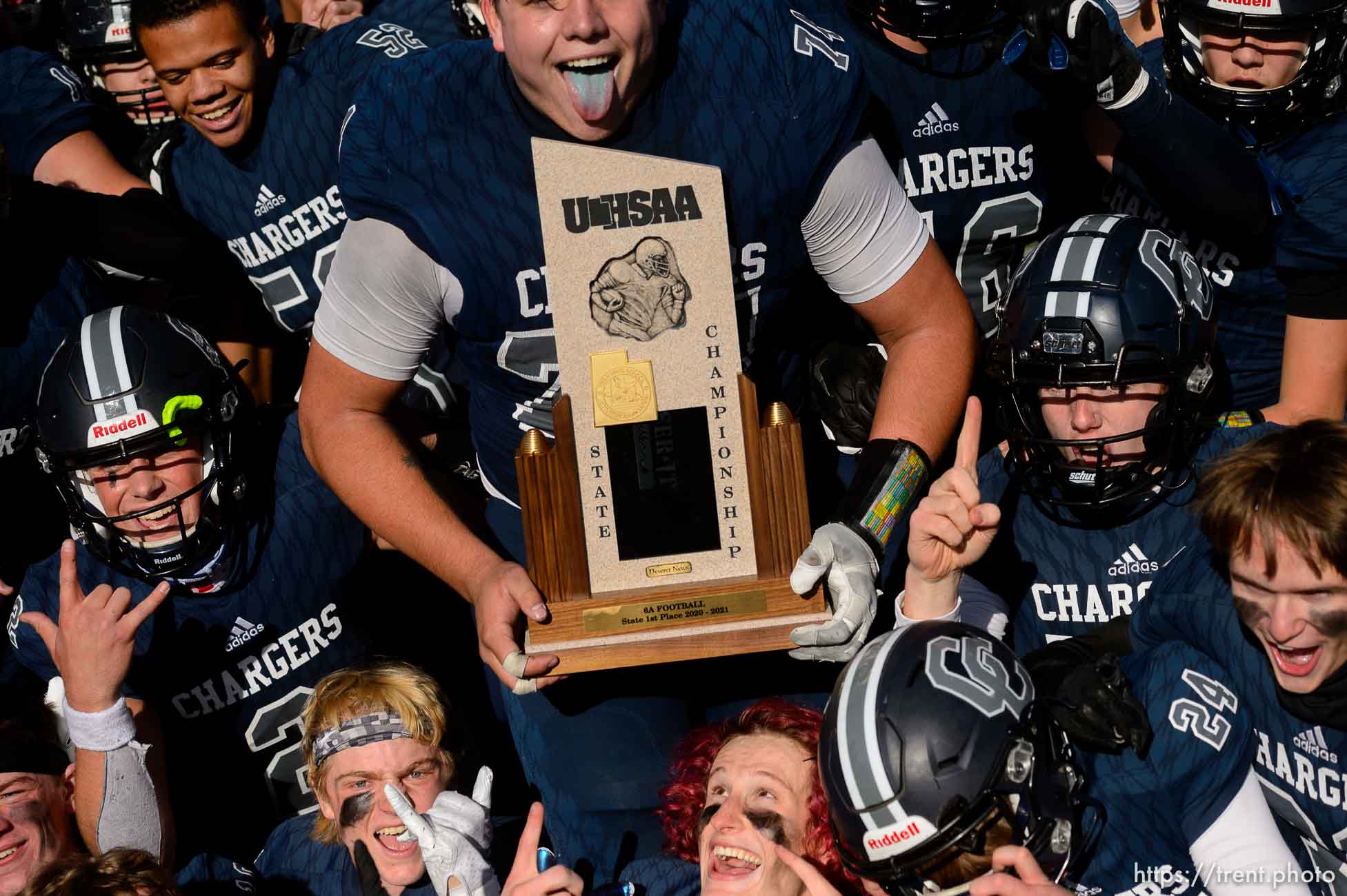 (Trent Nelson  |  The Salt Lake Tribune) Corner Canyon's Jackson Light holds the trophy while celebrating with teammates after the 6A state football championship game against Lone Peak at Cedar Valley High School in Eagle Mountain on Friday, Nov. 20, 2020.