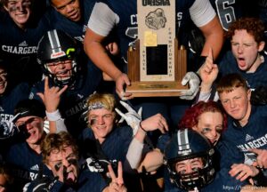 (Trent Nelson  |  The Salt Lake Tribune) Corner Canyon's Jackson Light holds the trophy while celebrating with teammates after the 6A state football championship game against Lone Peak at Cedar Valley High School in Eagle Mountain on Friday, Nov. 20, 2020.