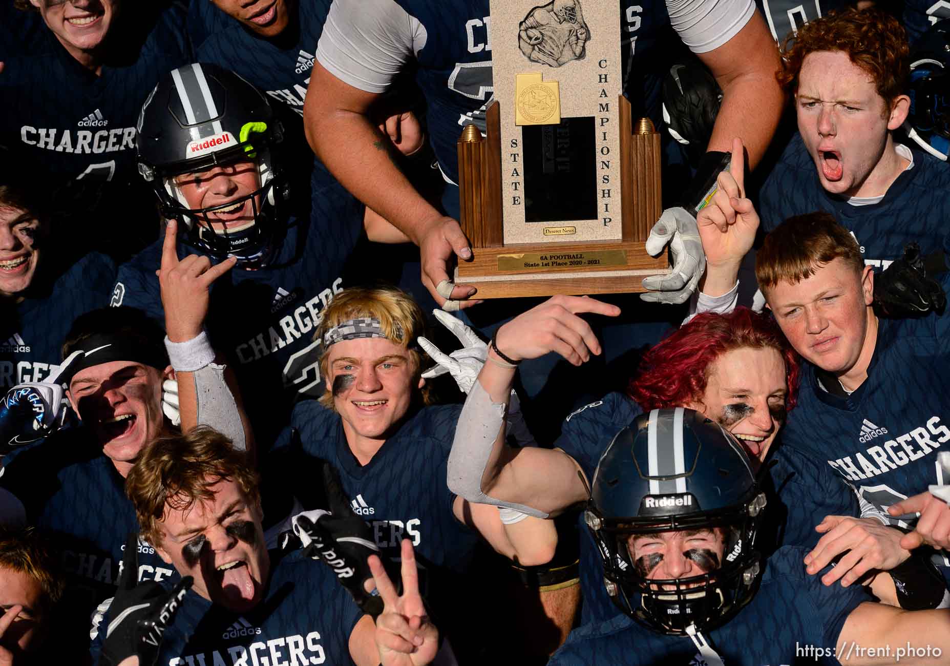 (Trent Nelson  |  The Salt Lake Tribune) Corner Canyon's Jackson Light holds the trophy while celebrating with teammates after the 6A state football championship game against Lone Peak at Cedar Valley High School in Eagle Mountain on Friday, Nov. 20, 2020.