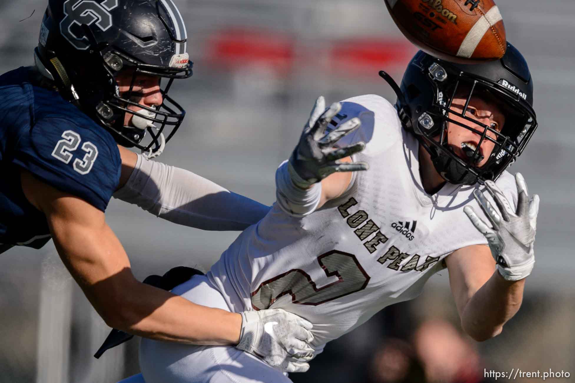 (Trent Nelson  |  The Salt Lake Tribune) Corner Canyon's Scott Iverson strips the ball from Lone Peak's Weston Covey as he nears the goal line during the 6A state football championship game at Cedar Valley High School in Eagle Mountain on Friday, Nov. 20, 2020.