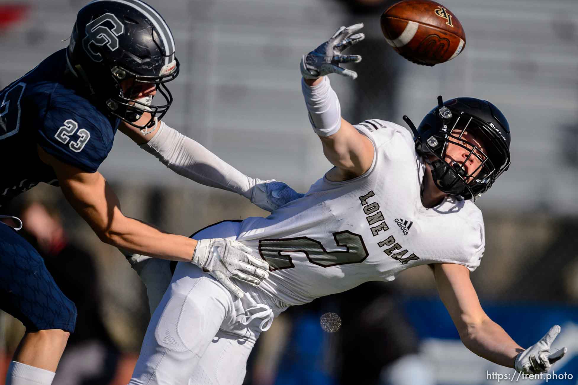 (Trent Nelson  |  The Salt Lake Tribune) Corner Canyon's Scott Iverson strips the ball from Lone Peak's Weston Covey as he nears the goal line during the 6A state football championship game at Cedar Valley High School in Eagle Mountain on Friday, Nov. 20, 2020.