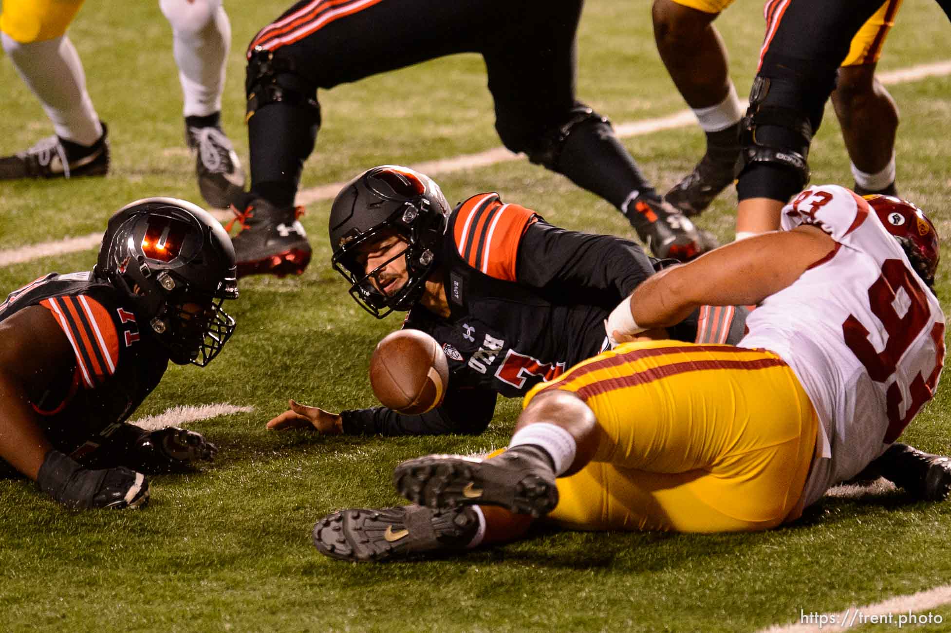 (Trent Nelson  |  The Salt Lake Tribune) Utah Utes quarterback Cameron Rising (7) fumbles the ball as he's hit by USC Trojans defensive lineman Marlon Tuipulotu (93), as the Utah Utes host the USC Trojans, NCAA football at Rice-Eccles Stadium in Salt Lake City on Saturday, Nov. 21, 2020.