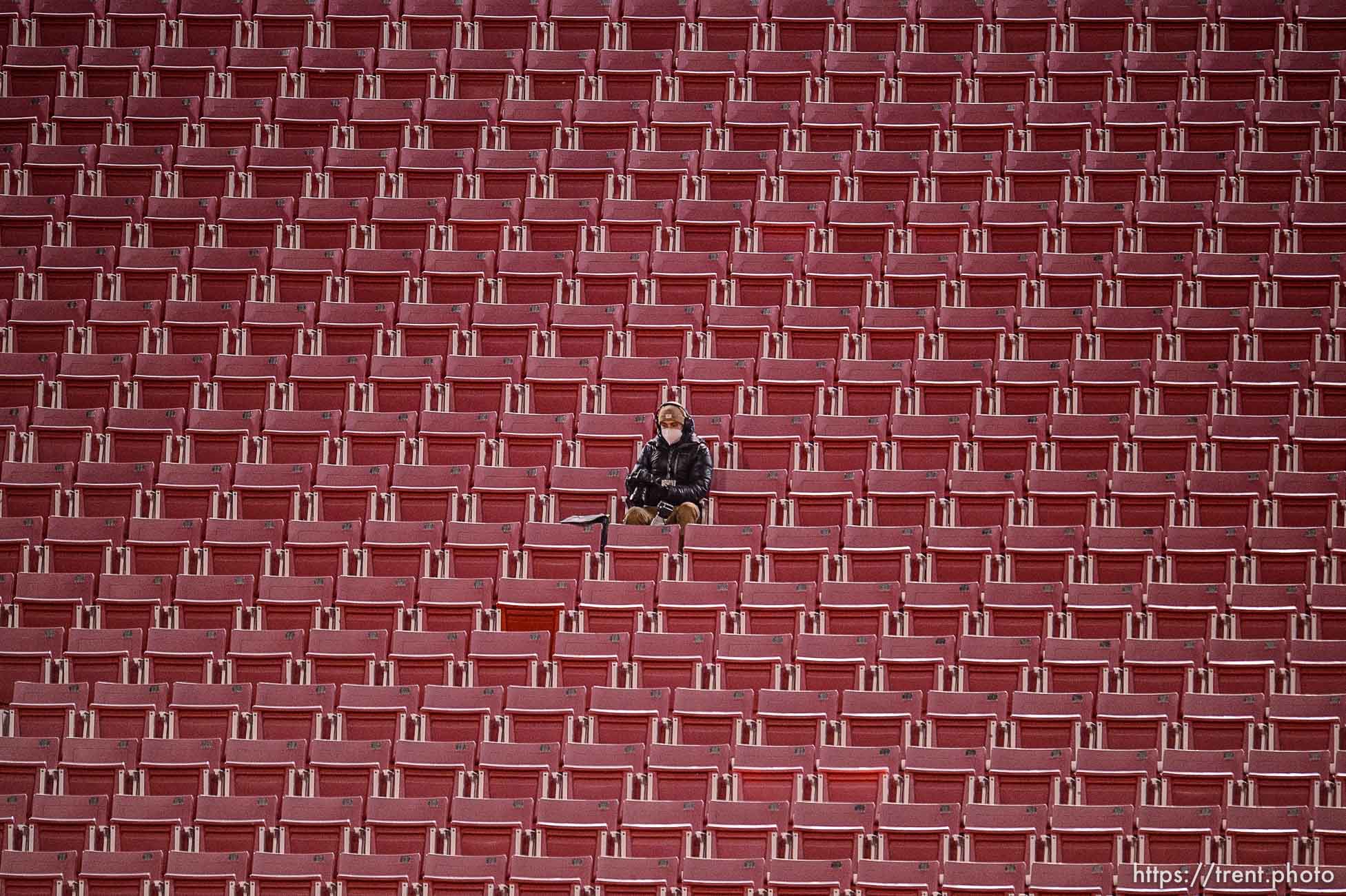 (Trent Nelson  |  The Salt Lake Tribune) A photographer surrounded by empty seats as the Utah Utes host the USC Trojans, NCAA football at Rice-Eccles Stadium in Salt Lake City on Saturday, Nov. 21, 2020.