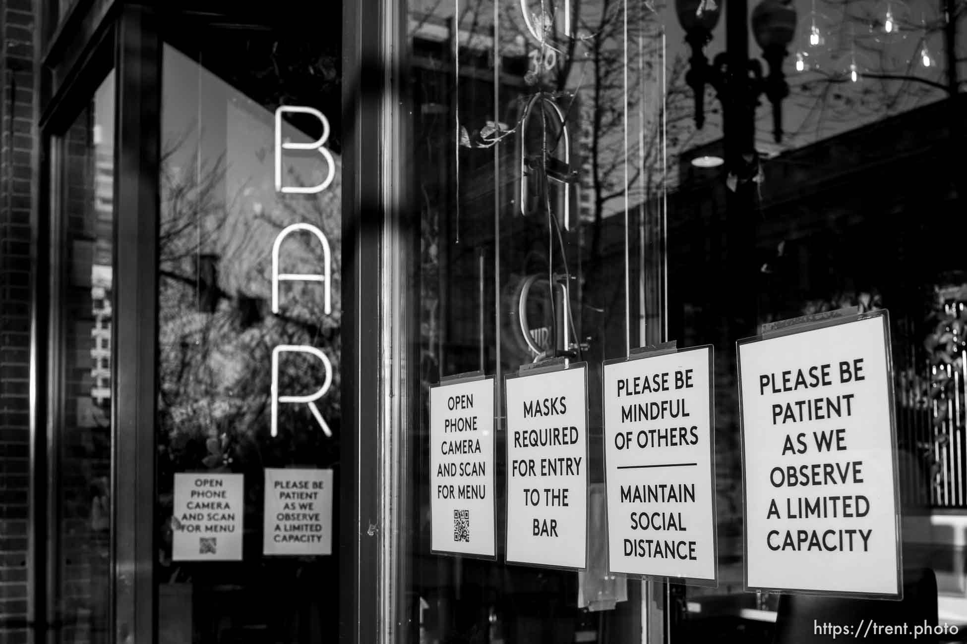 (Trent Nelson  |  The Salt Lake Tribune) Signs in the window of Alibi Bar & Place in Salt Lake City informing customers of COVID-19 precautions, on Wednesday, Nov. 25, 2020.