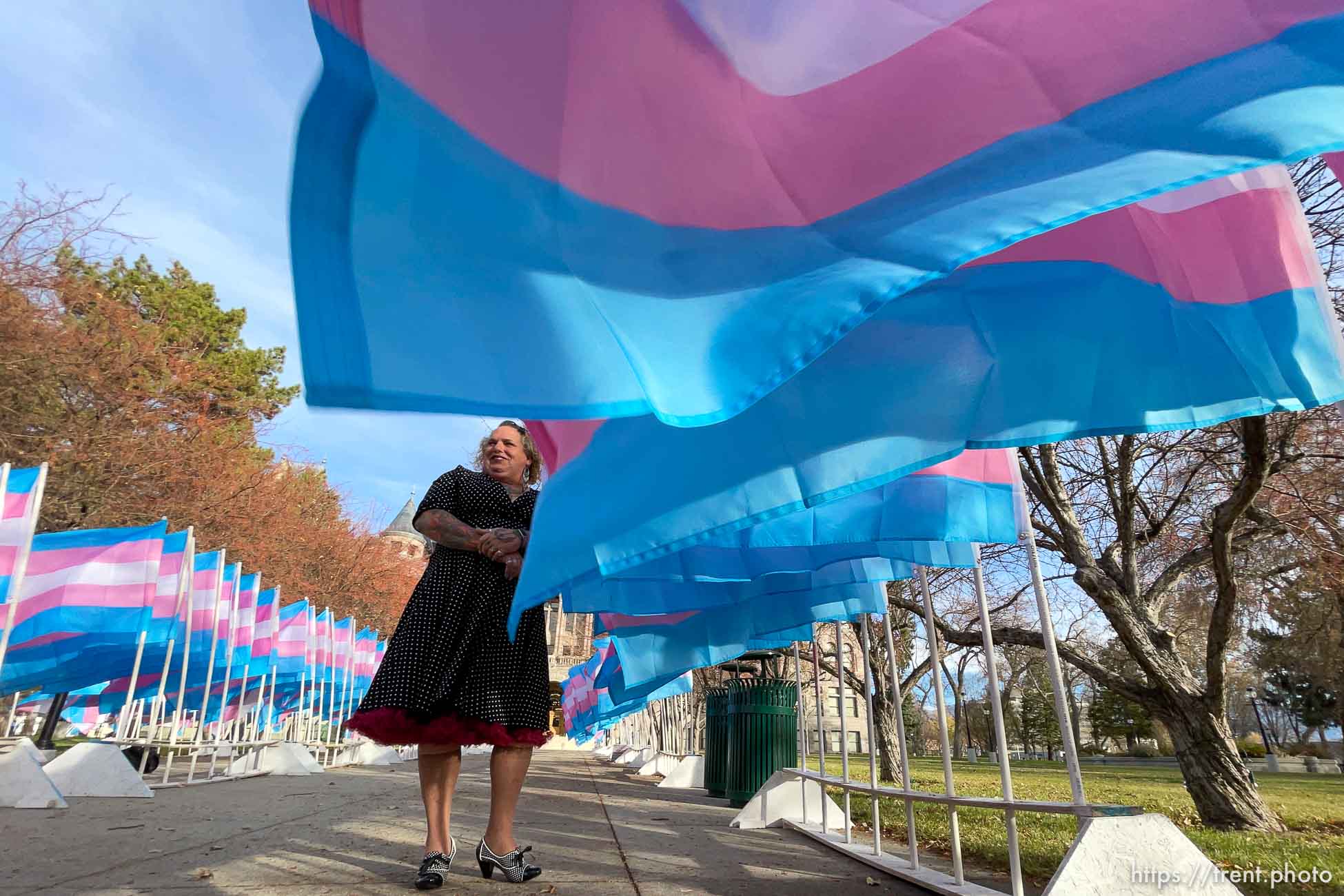 (Trent Nelson  |  The Salt Lake Tribune) Tisha Olsen of Project Rainbow poses for photographer Robin Pendergrast in front of Trans Pride flags marking Transgender Awareness Week at City Hall in Salt Lake City on Tuesday, Nov. 17, 2020. Each of the more than 300 Trans Pride flags stands in remembrance of a transgender person murdered in the last year.