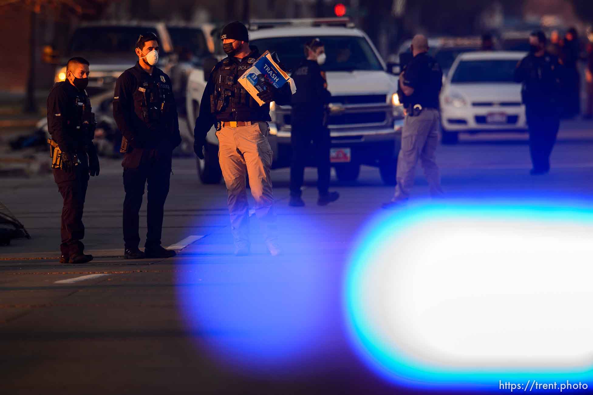 (Trent Nelson  |  The Salt Lake Tribune) Salt Lake City police officers working the cleanup of a series of campsites in Salt Lake City on Wednesday, Dec. 9, 2020.