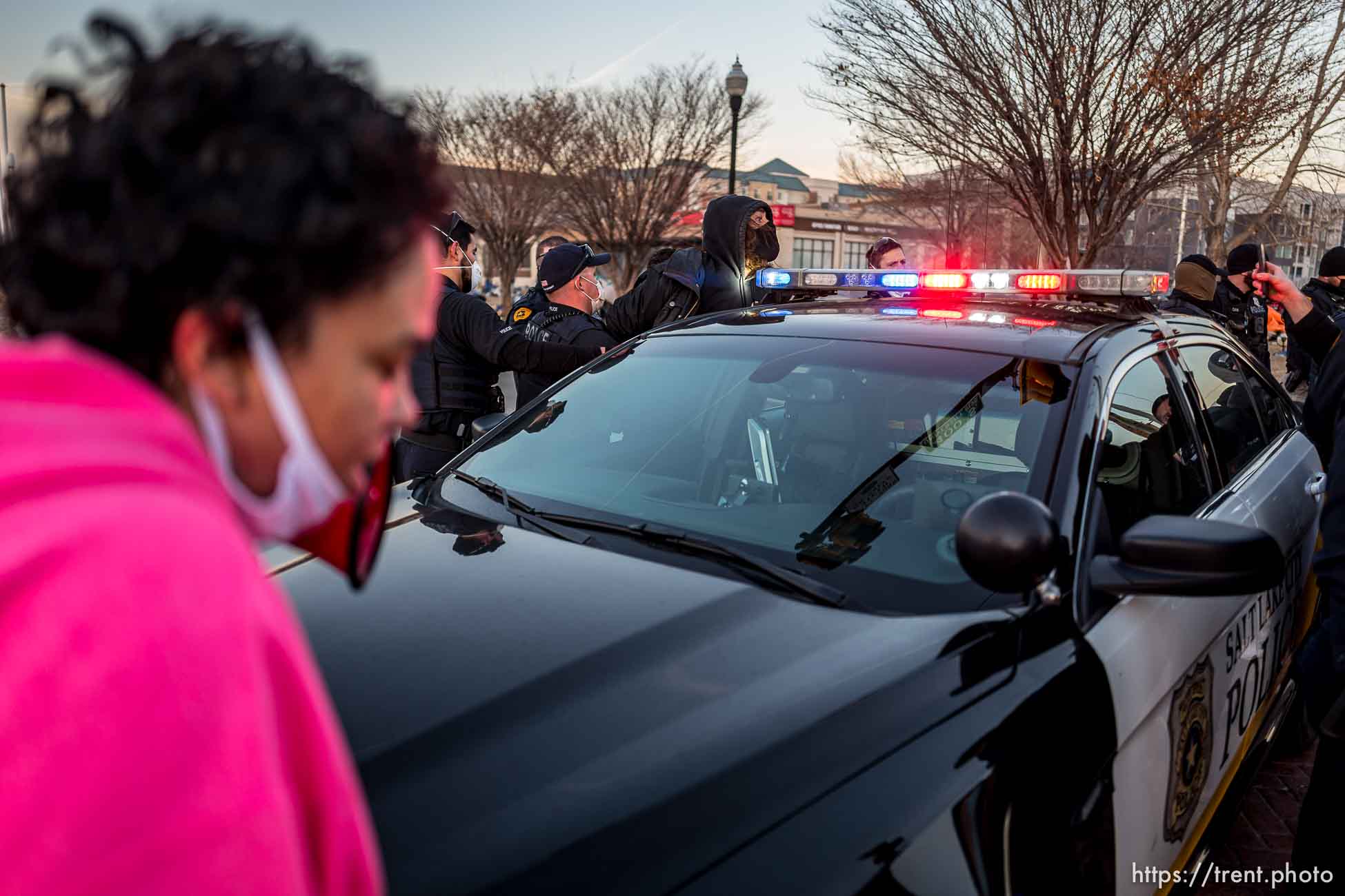 (Trent Nelson  |  The Salt Lake Tribune) Salt Lake City police officers arrest an activist while working the cleanup of a series of campsites in Salt Lake City on Wednesday, Dec. 9, 2020.