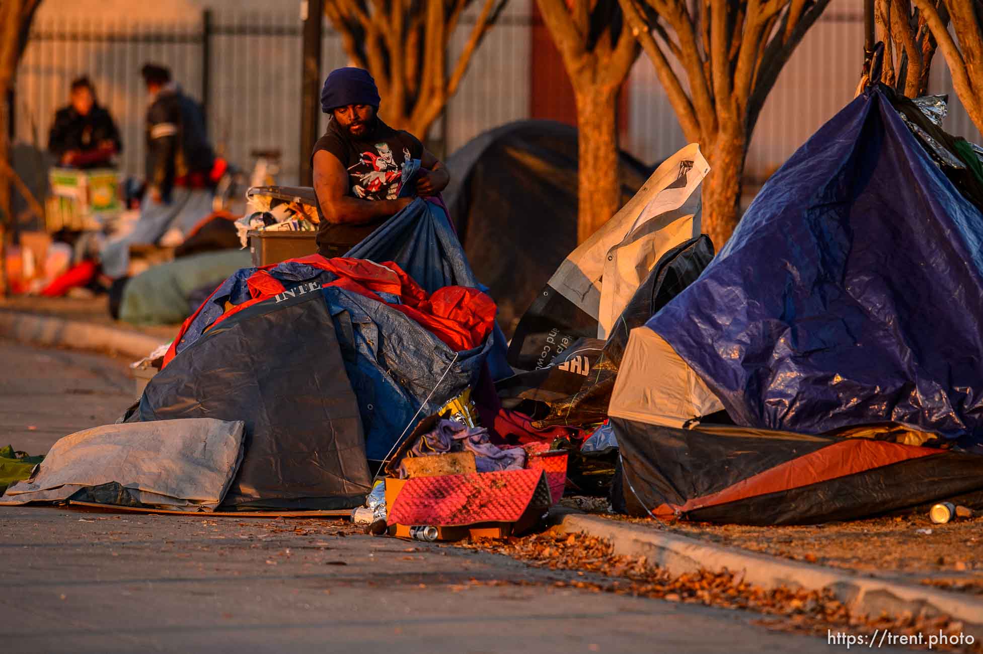 (Trent Nelson  |  The Salt Lake Tribune) A man packs up belongings as a cleanup crew from the health department approaches, in Salt Lake City on Wednesday, Dec. 9, 2020.