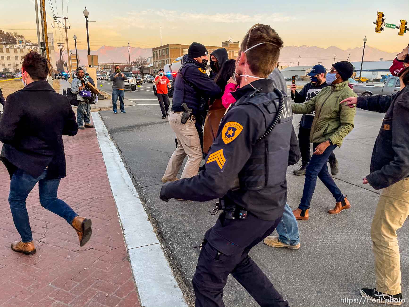 (Trent Nelson  |  The Salt Lake Tribune) Salt Lake City police officers working the cleanup of a series of campsites in Salt Lake City on Wednesday, Dec. 9, 2020.