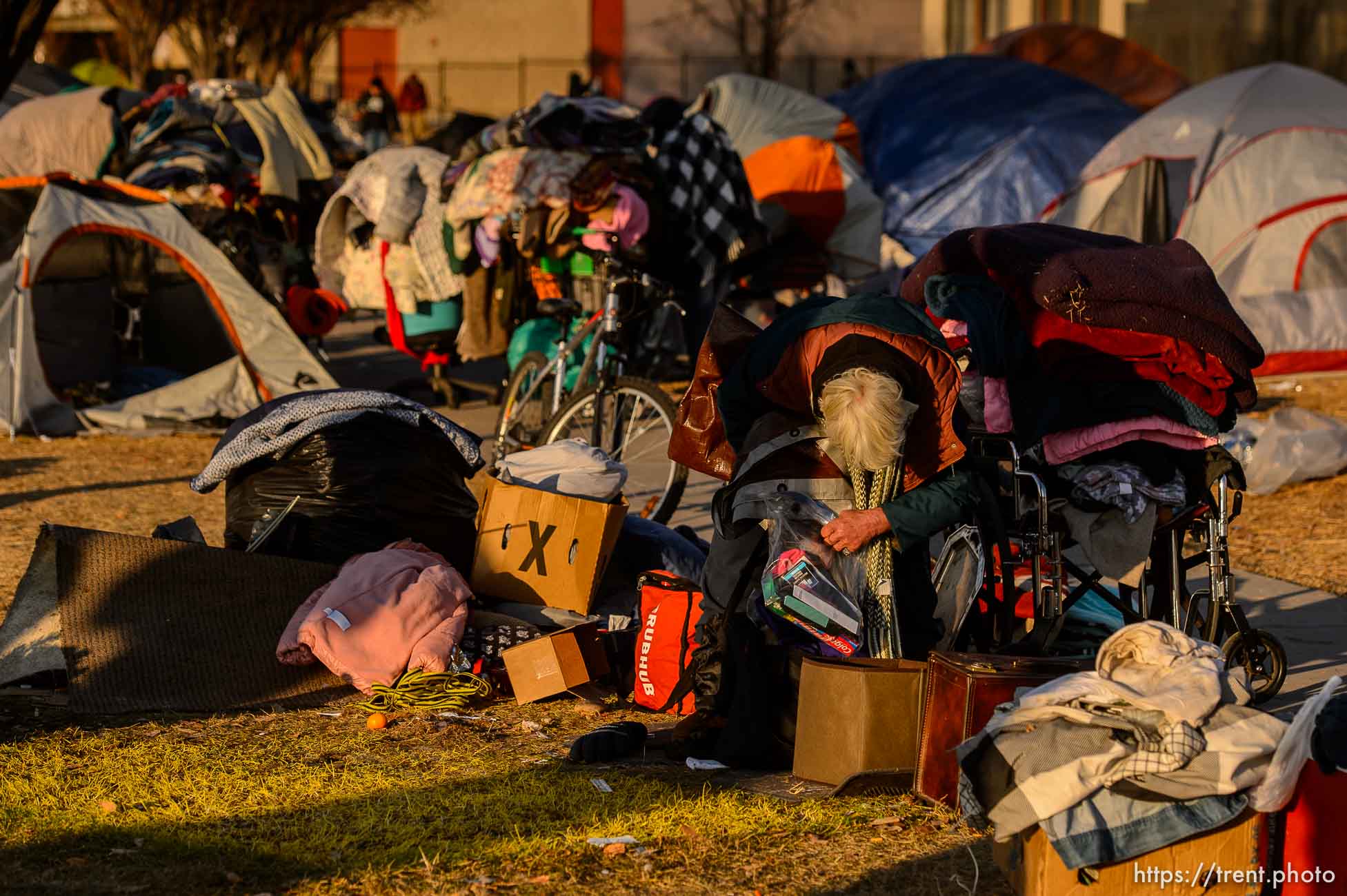 (Trent Nelson  |  The Salt Lake Tribune) A woman packs up belongings as a cleanup crew from the health department approaches, in Salt Lake City on Wednesday, Dec. 9, 2020.