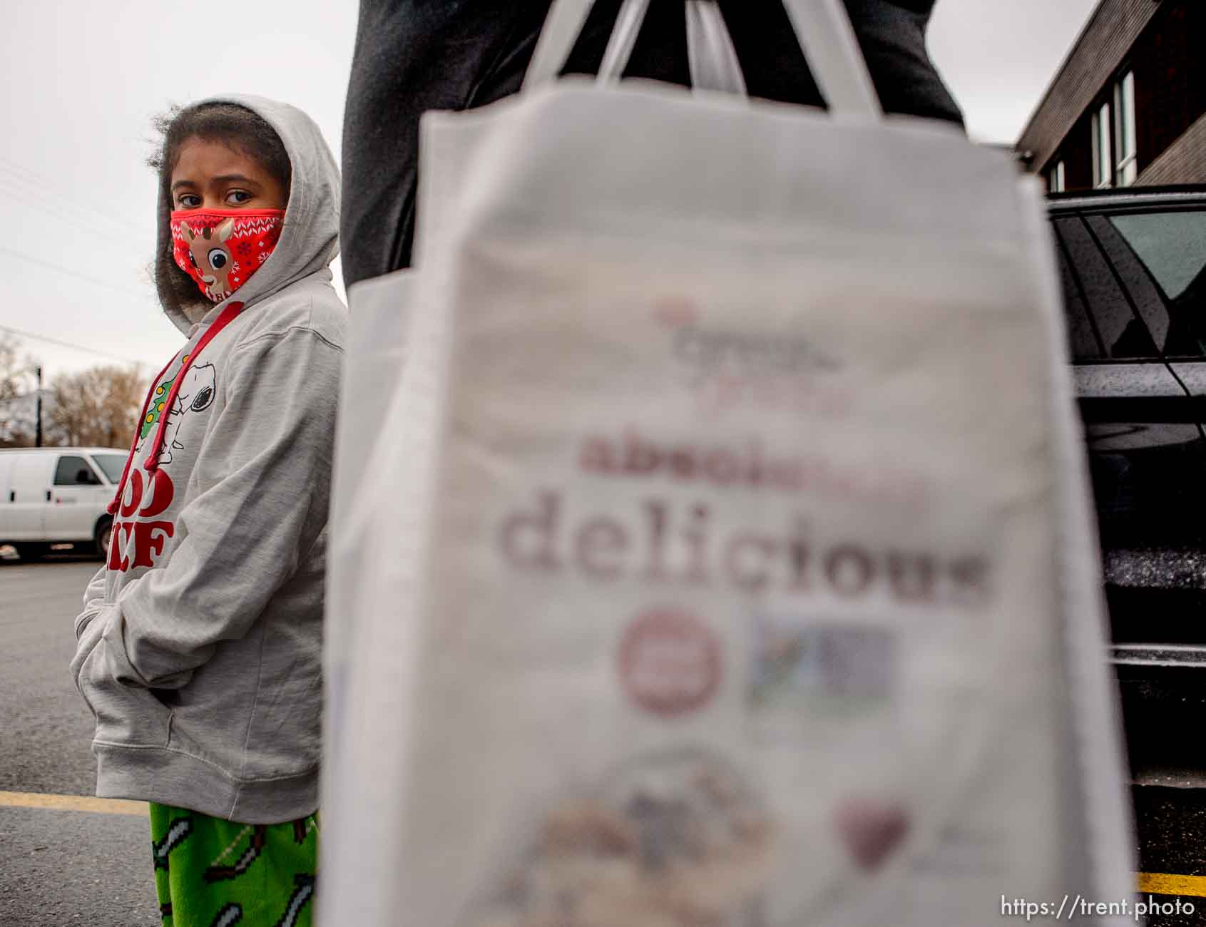 (Trent Nelson  |  The Salt Lake Tribune) Ma'rya stands next to her mother Maria after picking up bags of food at Liberty Elementary in Salt Lake City on Thursday, Dec. 17, 2020.