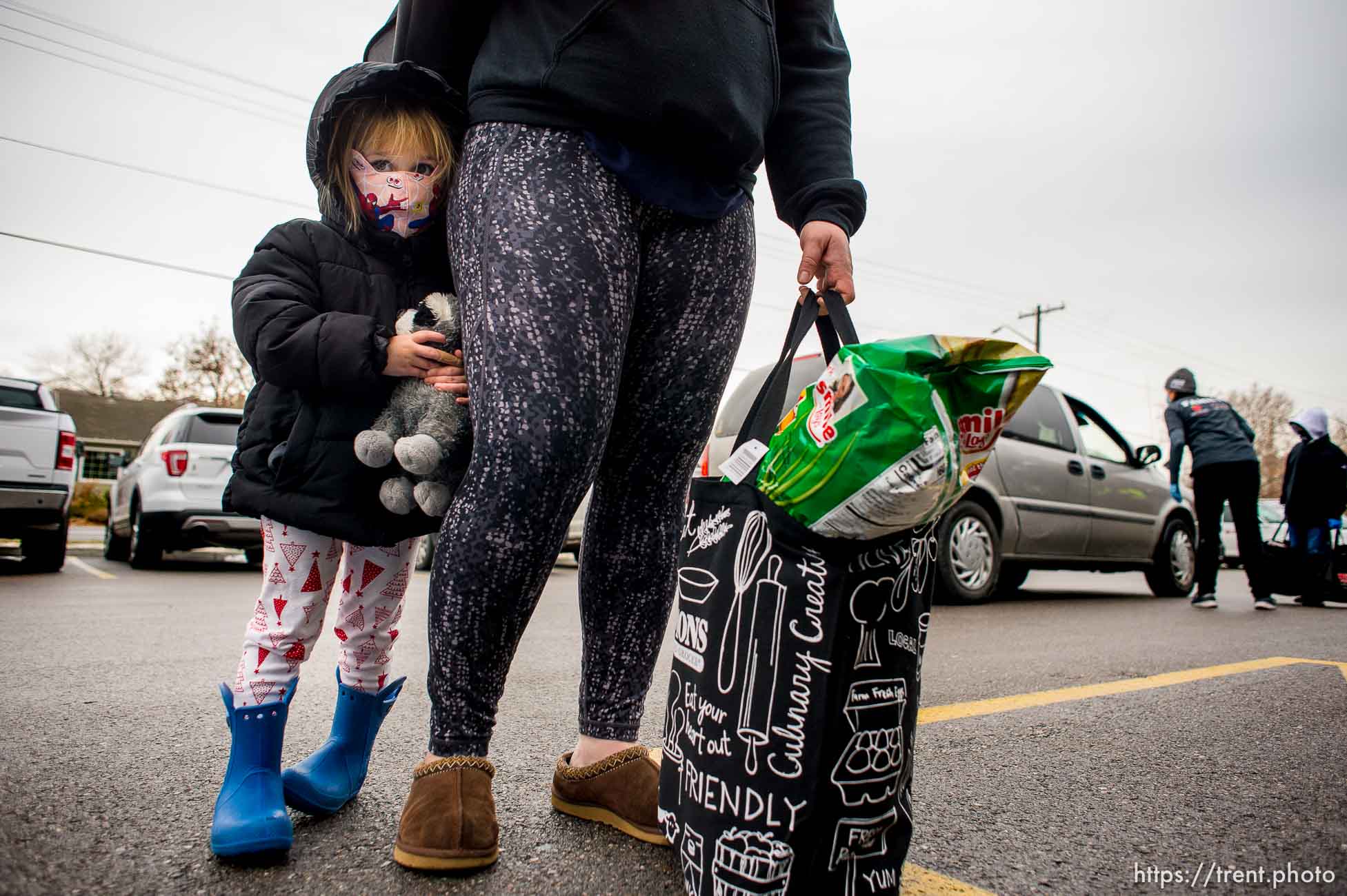 (Trent Nelson  |  The Salt Lake Tribune) Gia stands next to her mother Kajsa after picking up bags of food at Liberty Elementary in Salt Lake City on Thursday, Dec. 17, 2020.