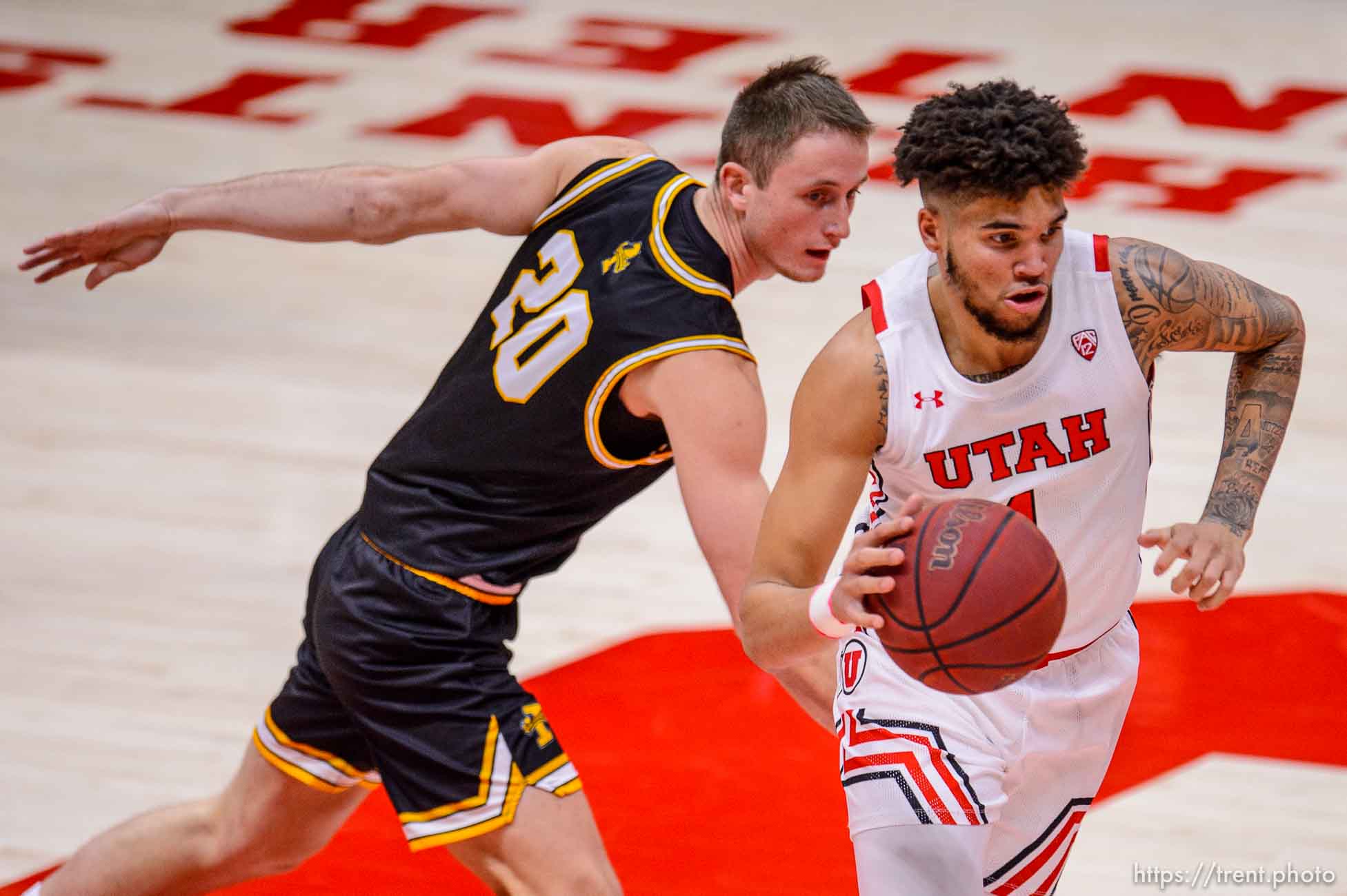 (Trent Nelson  |  The Salt Lake Tribune) Utah Utes forward Timmy Allen (1) drives past Idaho Vandals guard Ethan Kilgore (20) as Utah hosts Idaho, NCAA basketball in Salt Lake City on Friday, Dec. 18, 2020.