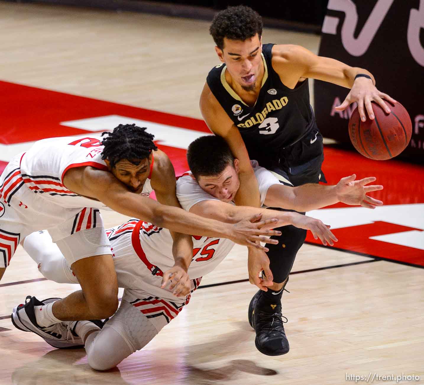 (Trent Nelson  |  The Salt Lake Tribune) Utah Utes guard Ian Martinez (2), Utah Utes guard Rylan Jones (15), and Colorado Buffaloes guard Maddox Daniels (3) scramble for a loose ball as Utah hosts Colorado, NCAA basketball in Salt Lake City on Monday, Jan. 11, 2021.