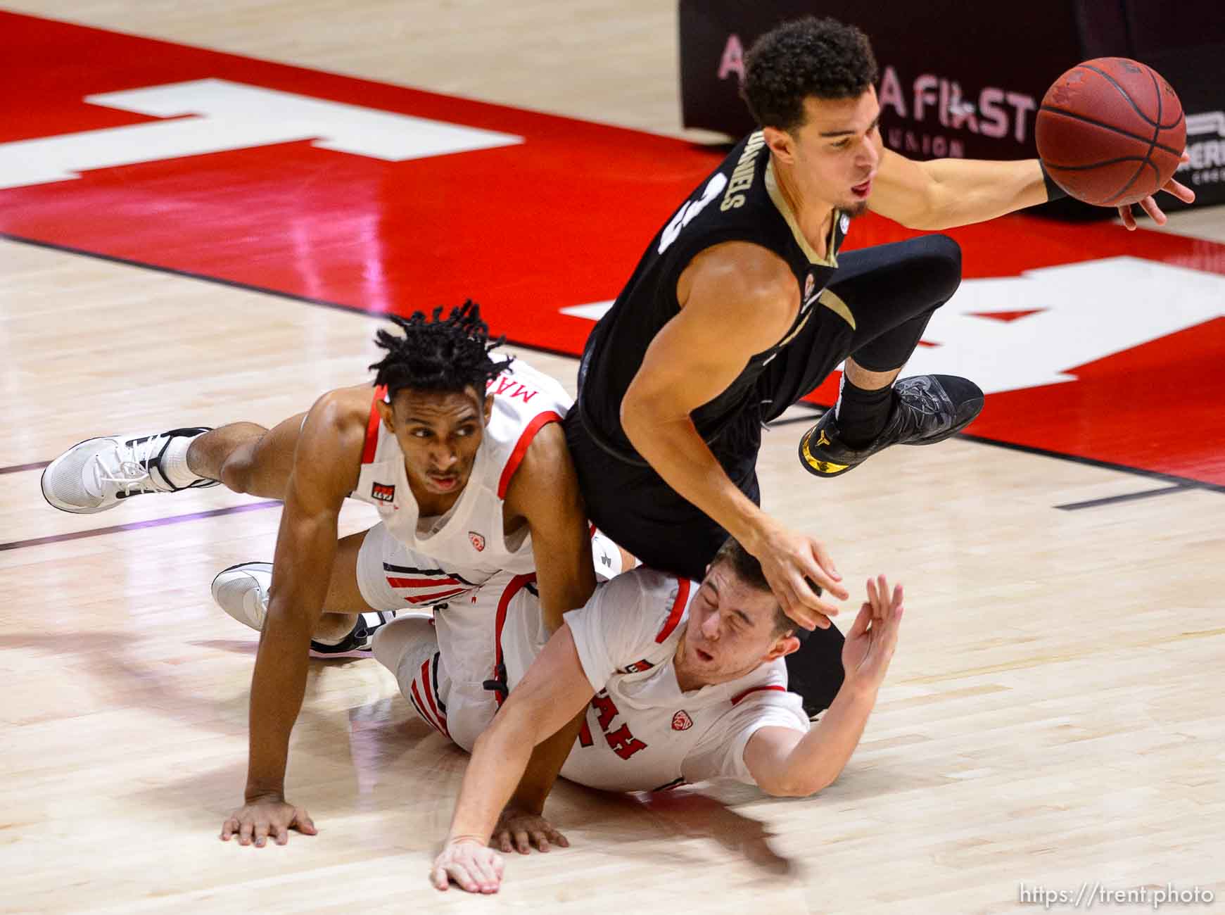 (Trent Nelson  |  The Salt Lake Tribune) Utah Utes guard Ian Martinez (2), Utah Utes guard Rylan Jones (15), and Colorado Buffaloes guard Maddox Daniels (3) scramble for a loose ball as Utah hosts Colorado, NCAA basketball in Salt Lake City on Monday, Jan. 11, 2021.