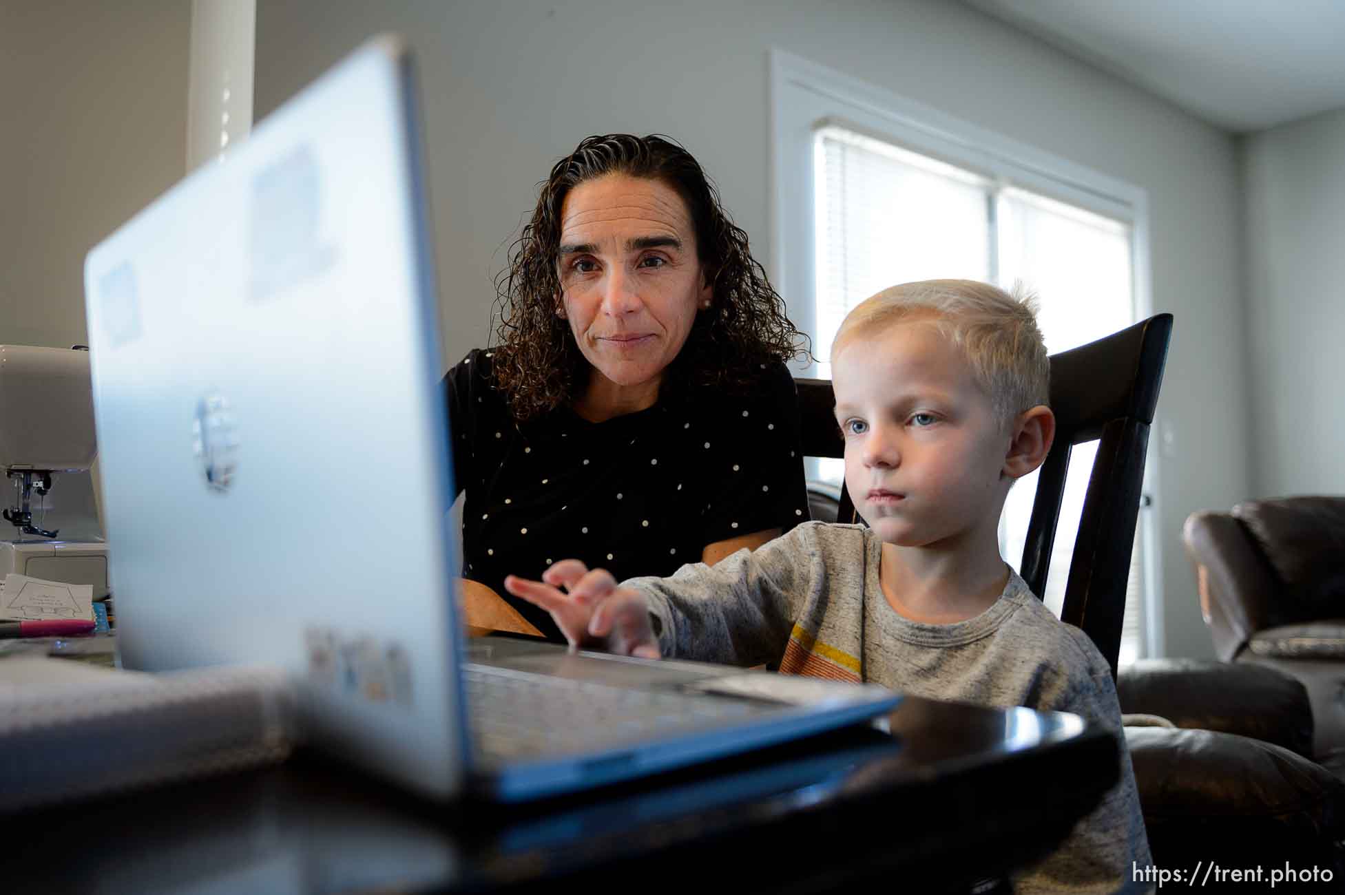 (Trent Nelson  |  The Salt Lake Tribune) Jeannette Bowen works with her son Sam on his online schoolwork at home in Murray on Wednesday, Jan. 13, 2021.