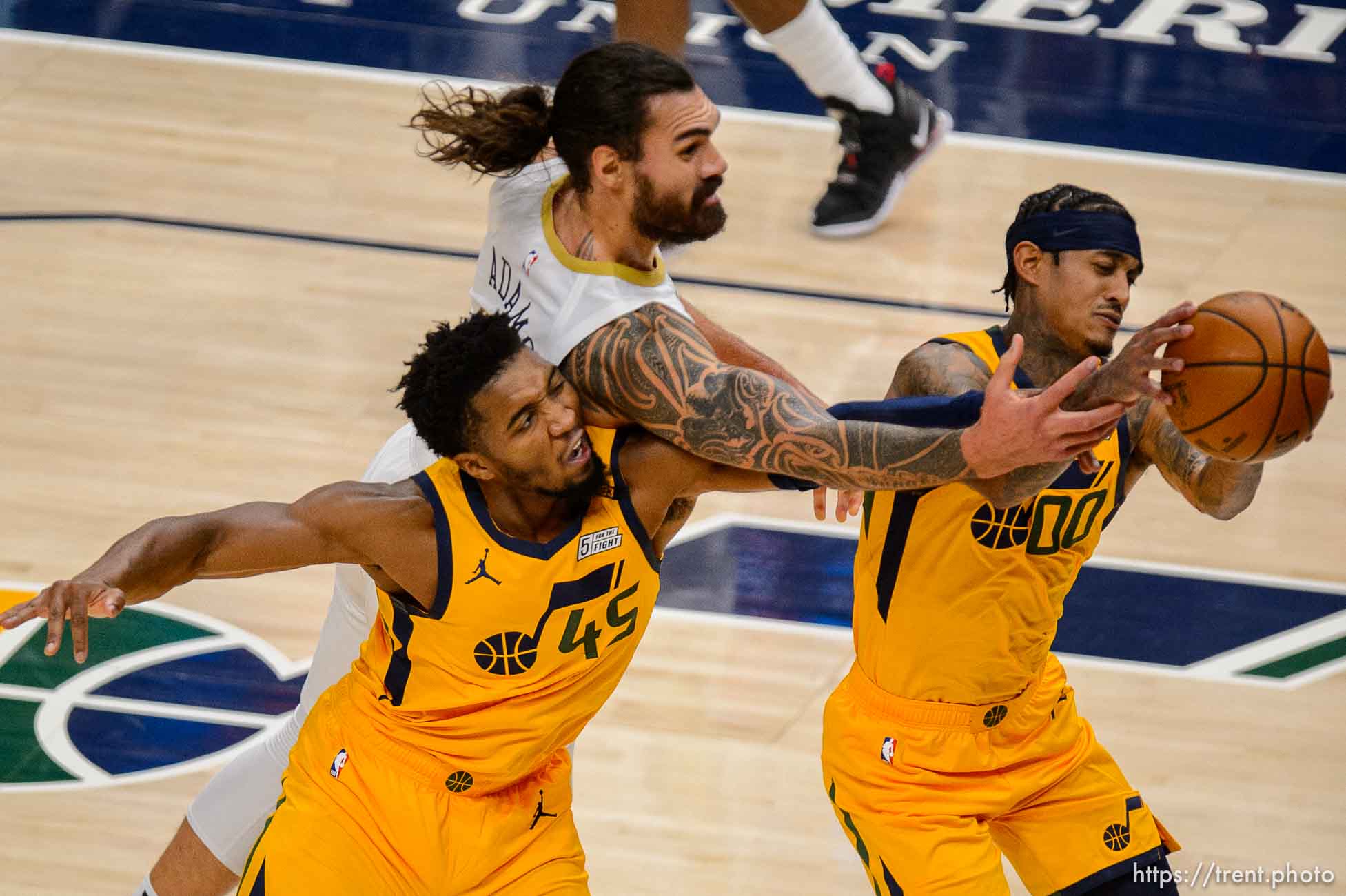 (Trent Nelson  |  The Salt Lake Tribune) Utah Jazz guard Donovan Mitchell (45), New Orleans Pelicans center Steven Adams (12), and Utah Jazz guard Jordan Clarkson (00) reach for the ball as the Utah Jazz host the New Orleans Pelicans, NBA basketball in Salt Lake City on Tuesday, Jan. 19, 2021.