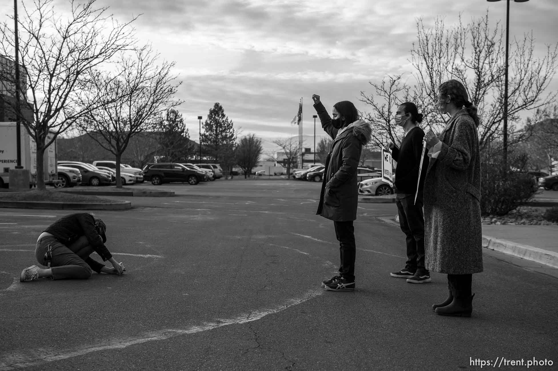 (Trent Nelson  |  The Salt Lake Tribune) Mark Lavelle, David Alonso, and Emma Lowe rally in front of the office of Rep. Burgess Owens, R-Utah, in West Jordan on Thursday, Jan. 21, 2021. The event is part of a nationwide effort by the Sunrise Movement, a national youth- and millenial-lead activist group, aiming to achieve racial, economic, and climate justice through the Green New Deal.